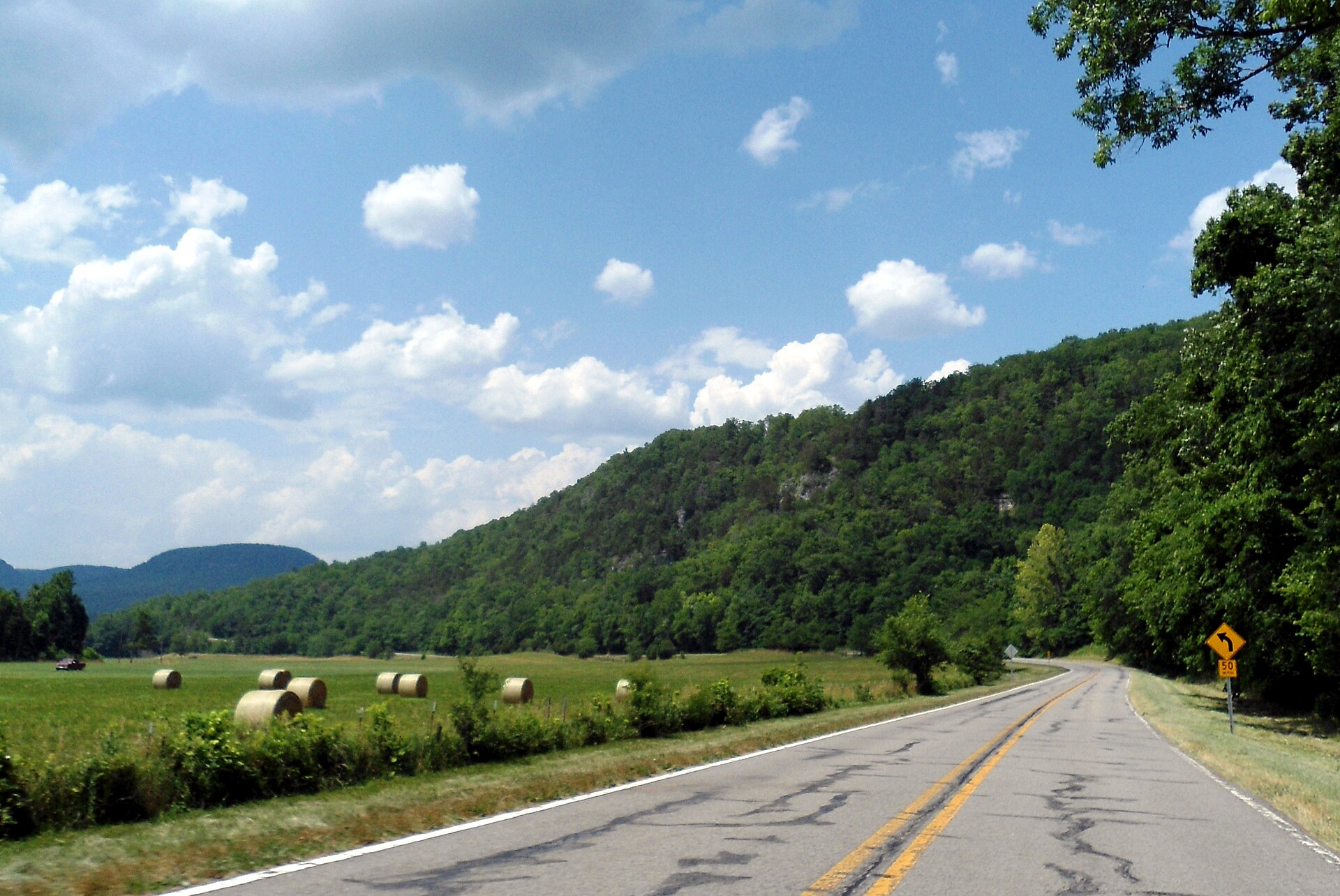 Fields and wooded hills along Highway 21 in Boxley Valley, Arkansas.