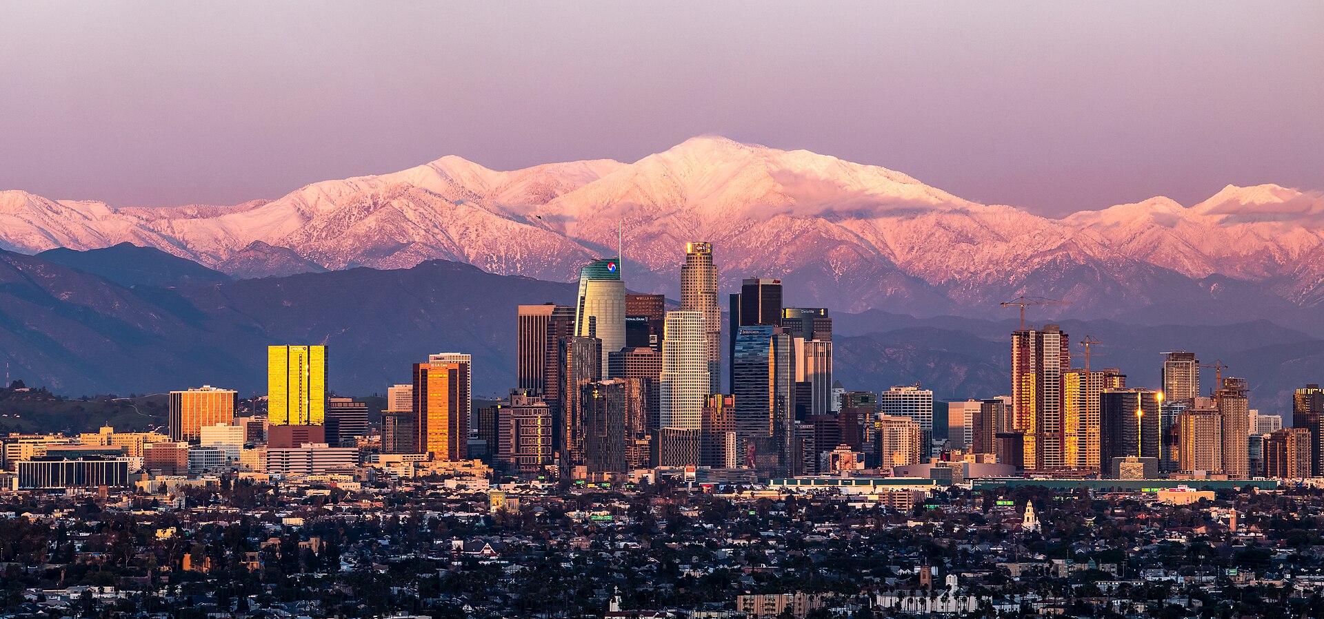February shot of downtown Los Angeles sunset with Mount Baldy in the background after a large snow storm. — California