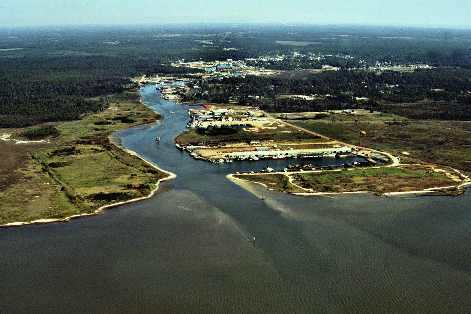 Aerial view of the harbor entrance from the Gulf of Mexico at Bayou La Batre, Alabama, USA. View is to the northwest.