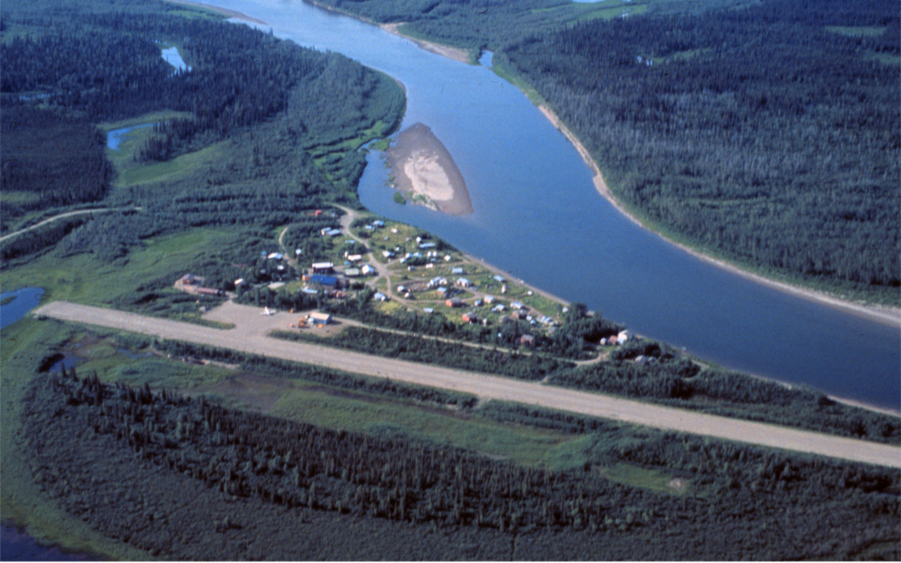 Aerial view of Kobuk, the airstrip, and the Kobuk River in the summer — Alaska