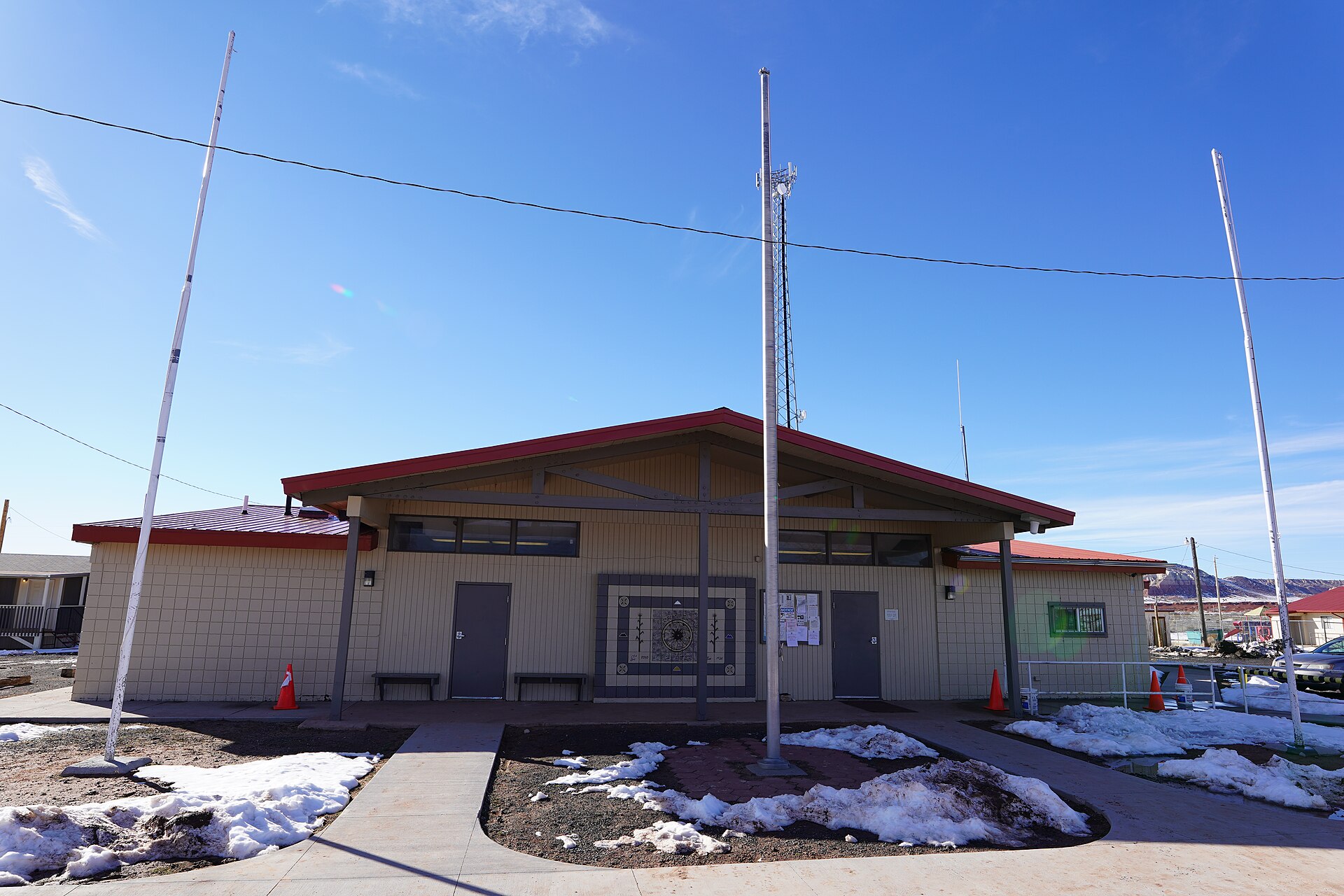 The photograph is of the Chapter House for Cornfields Chapter of the Navajo Nation. Like most chapter houses this one also has its main entrance opening to the east. Photograph taken on 2019-02-27T22:47:11Z. — Arizona