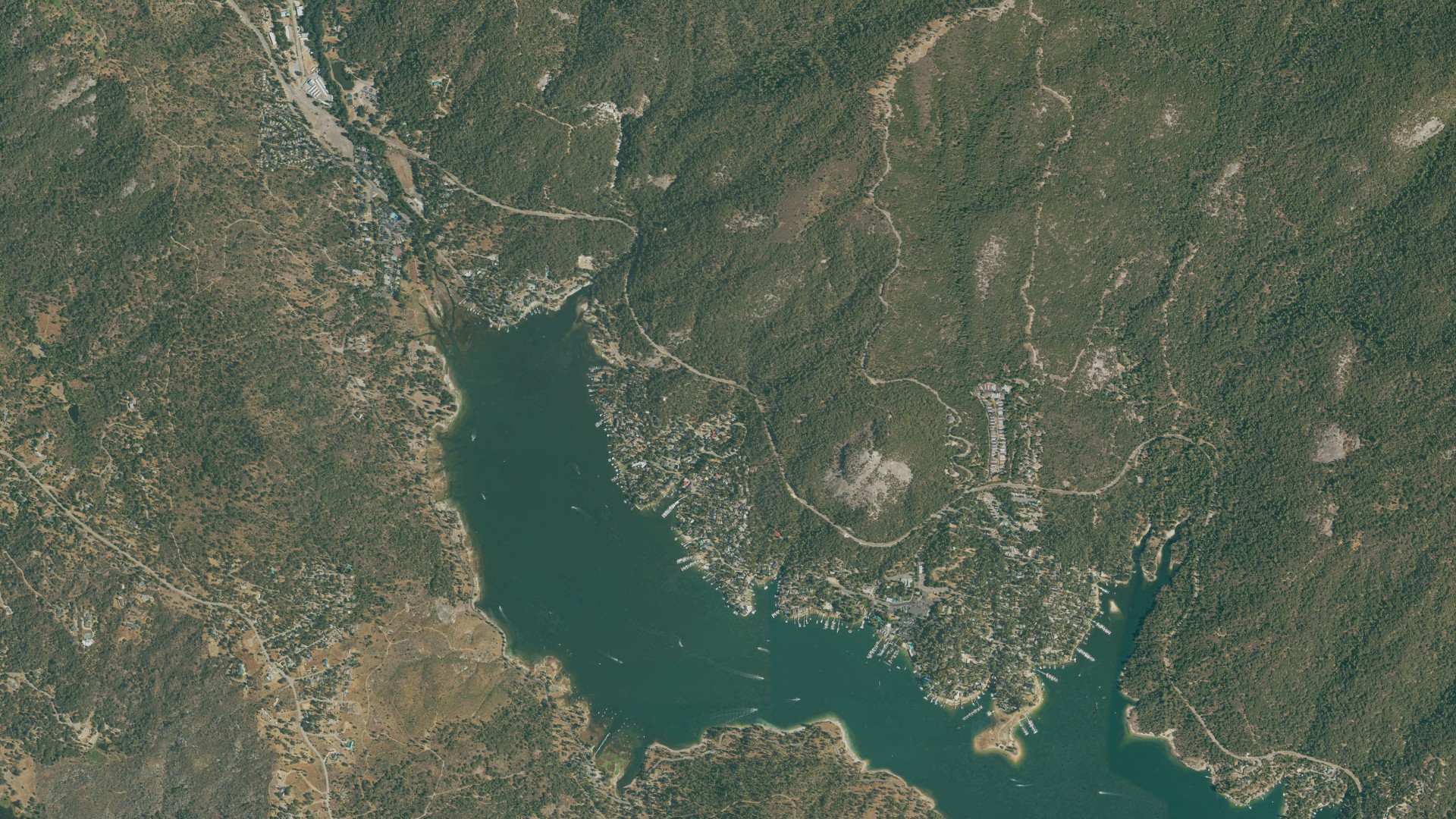 Natural-color aerial photograph of land around Bass Lake, California