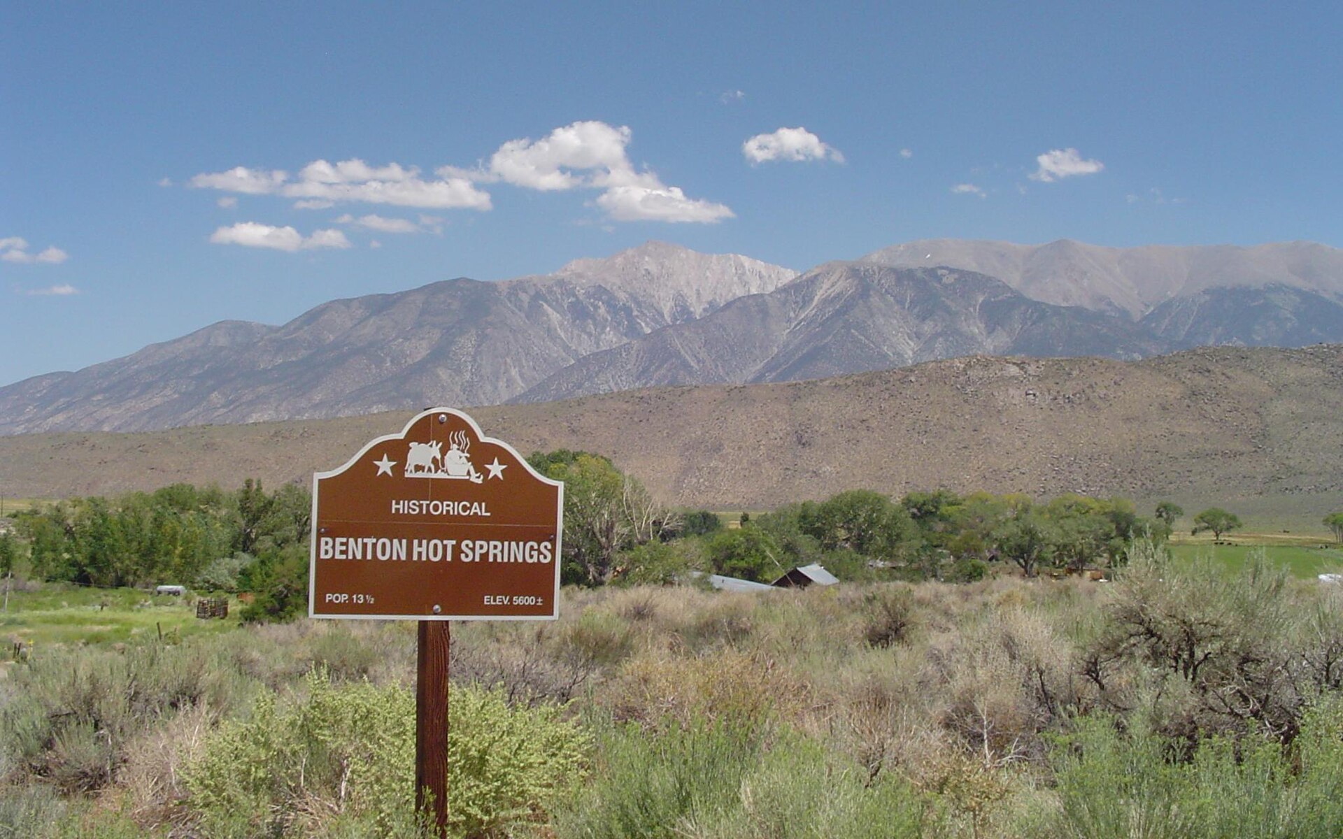 Historical marker sign for Benton Hot Springs, with the Eastern Sierra, in Mono County, California.
