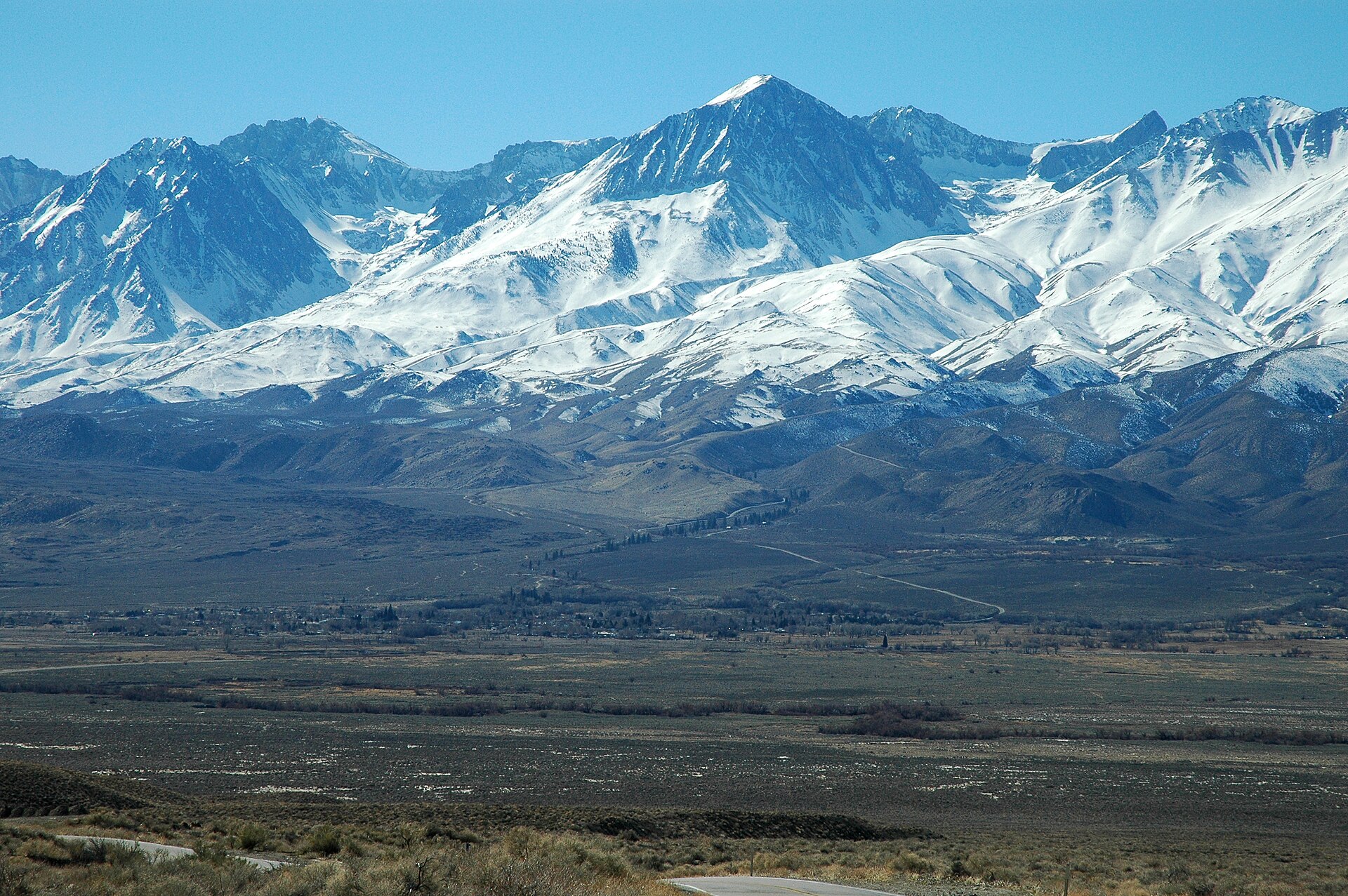 The entire town of Big Pine, California, is in the middle of the photo, in the Owens Valley with the Eastern Sierra as backdrop. View is shot from the lower slope of the White Mountains (California).