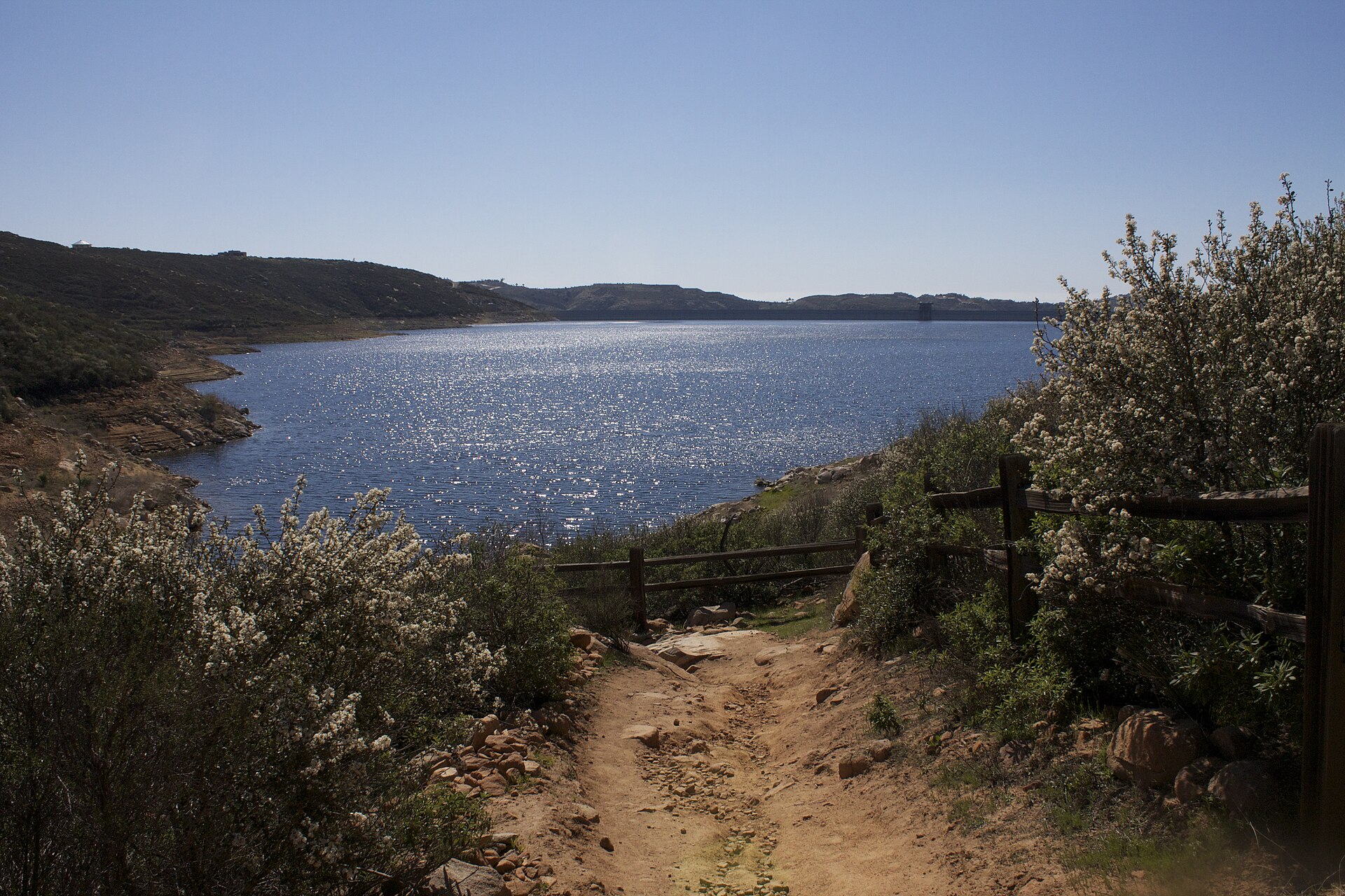 This is a photo of the Olivenhain dam & reservoir, which is located within the Elfin Forest Recreational Reserve. It is visible from part of the 11 miles of hiking that the reserve offers. — California
