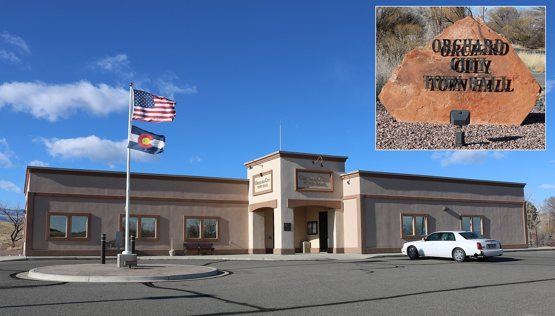 The town hall of Orchard City, Colorado, located at 9661 2100 Road, Orchard City, Colorado 81410. The inset shows the sign that's along the road at the bottom of the property's driveway.