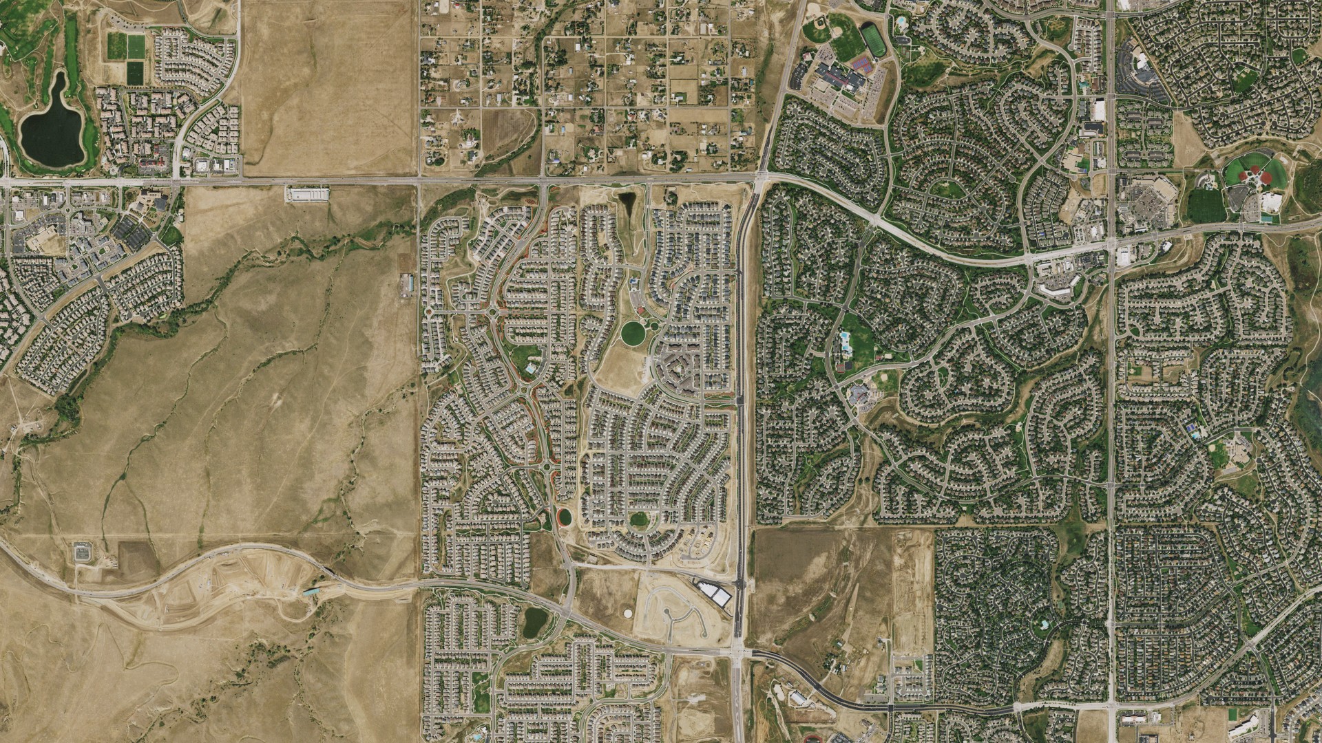 Natural-color aerial photograph of land around Sierra Ridge, Colorado