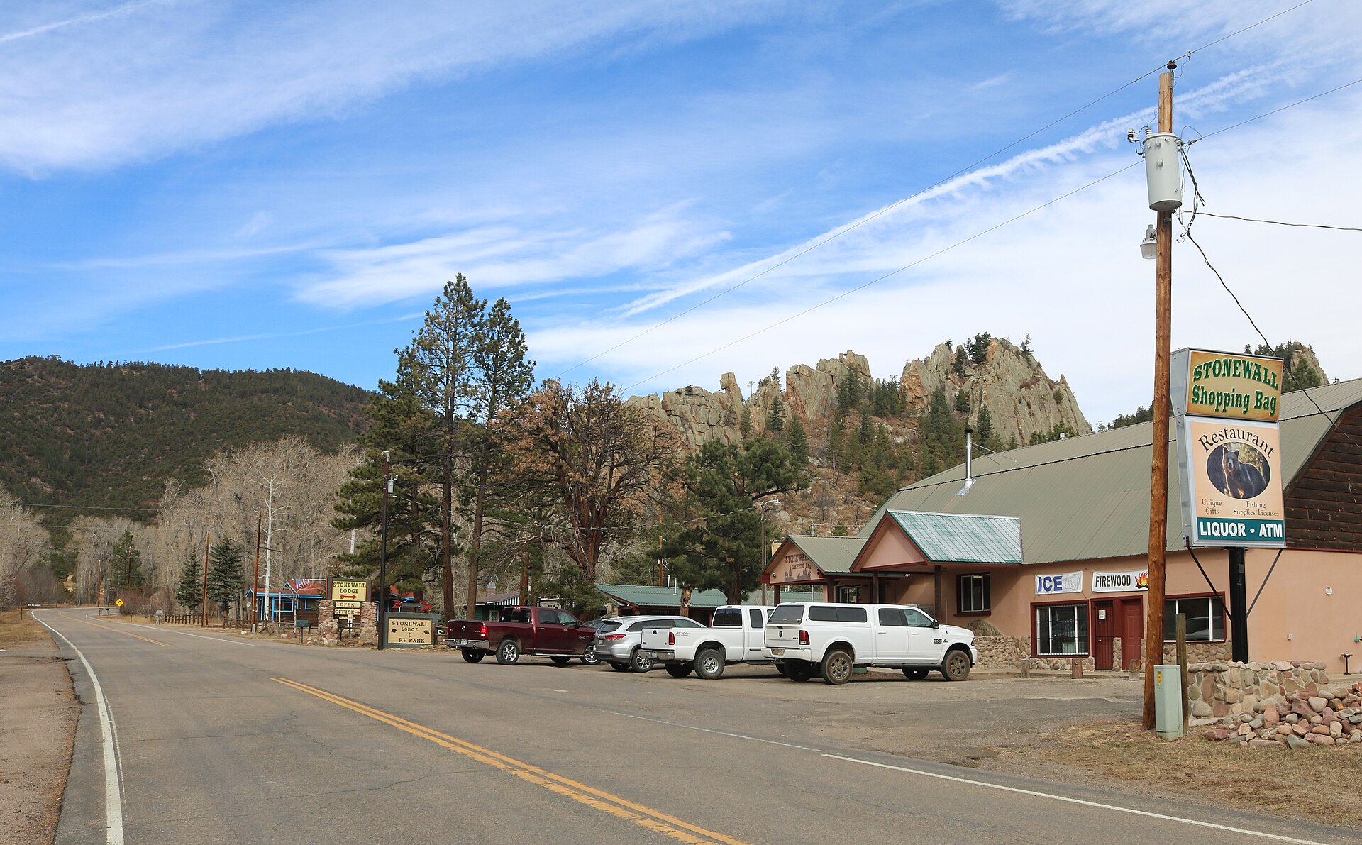 A view of Stonewall Gap, Colorado in Las Animas County. Colorado State Highway 12 is the road in the picture, and part of the Dakota Wall is visible behind and above the store.