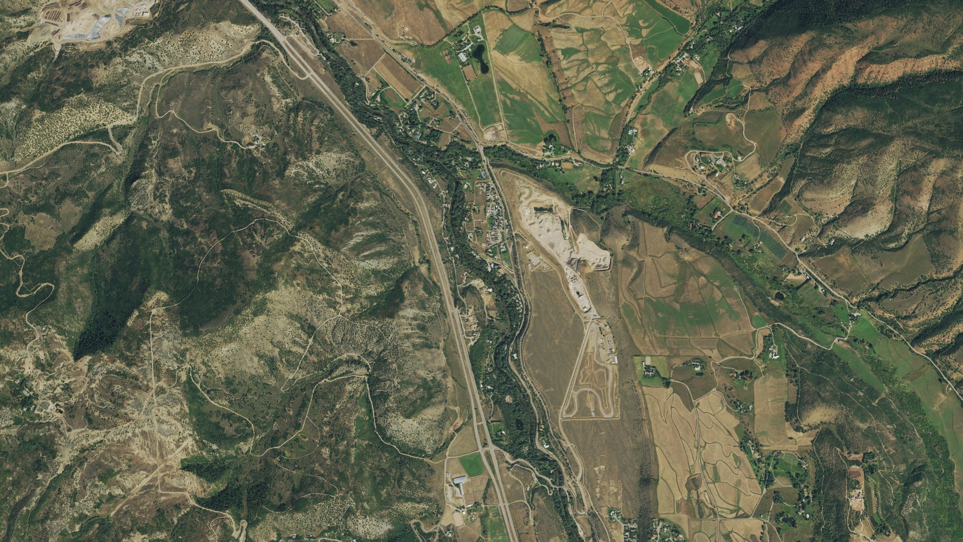 Natural-color aerial photograph of land around Woody Creek, Colorado