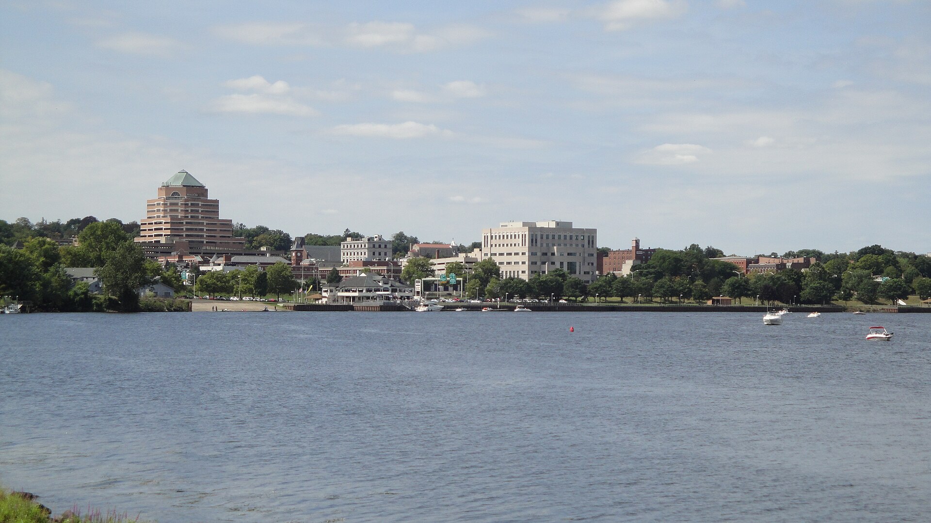 City of Middletown, Connecticut as seen from River Road, looking west/northwest along the major bend in the Connecticut River, showing Harbor Park and buildings along Main Street and downtown.