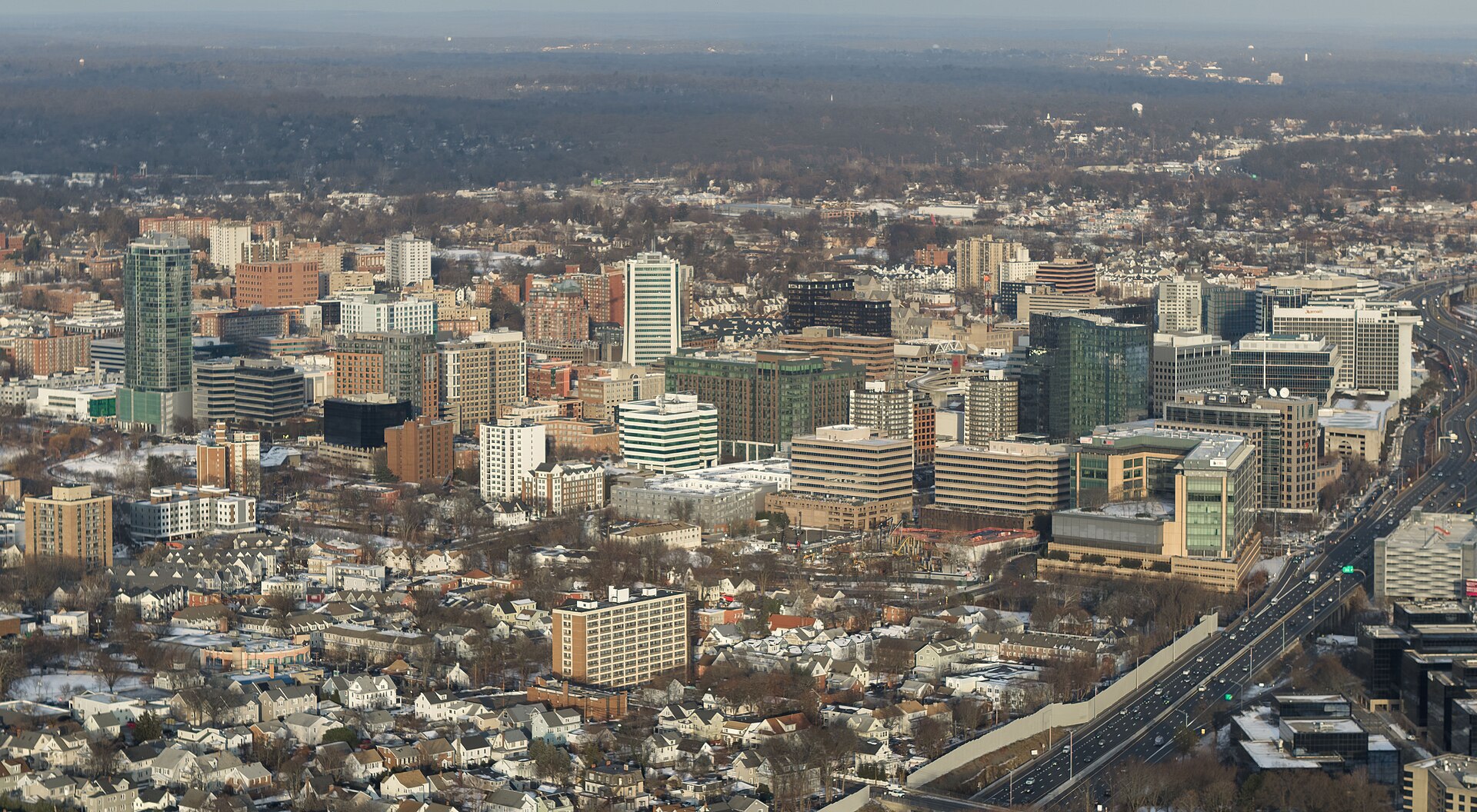 Aerial view of downtown Stamford, Connecticut, seen from the southwest in winter. Interstate 95 and the Metro-North/Amtrak rail corridor run along the east side of the city.