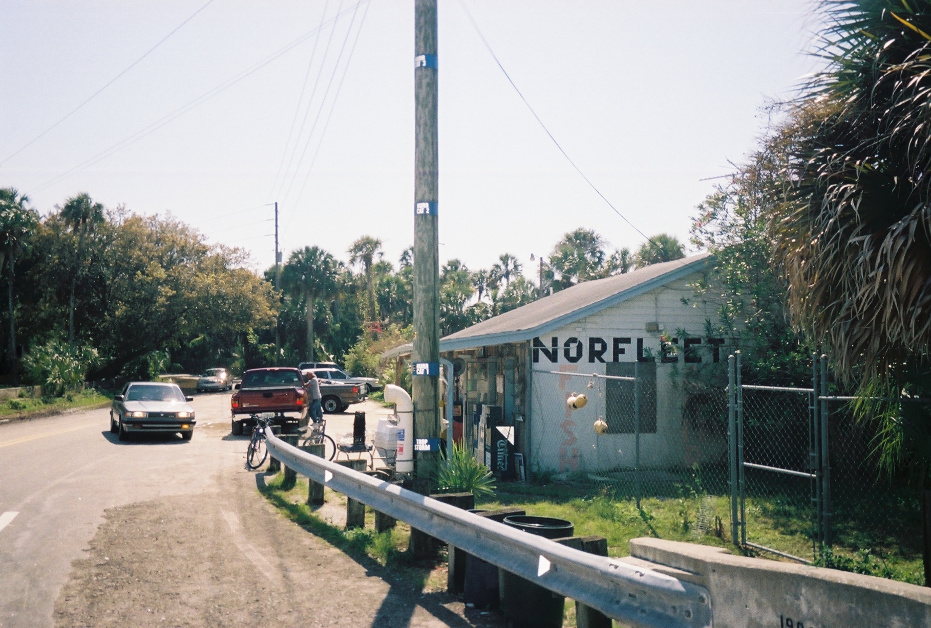 Blue hurricane-flood markers on a telephone pole in front of a bait shop and convenience store in Aripeka, Florida.