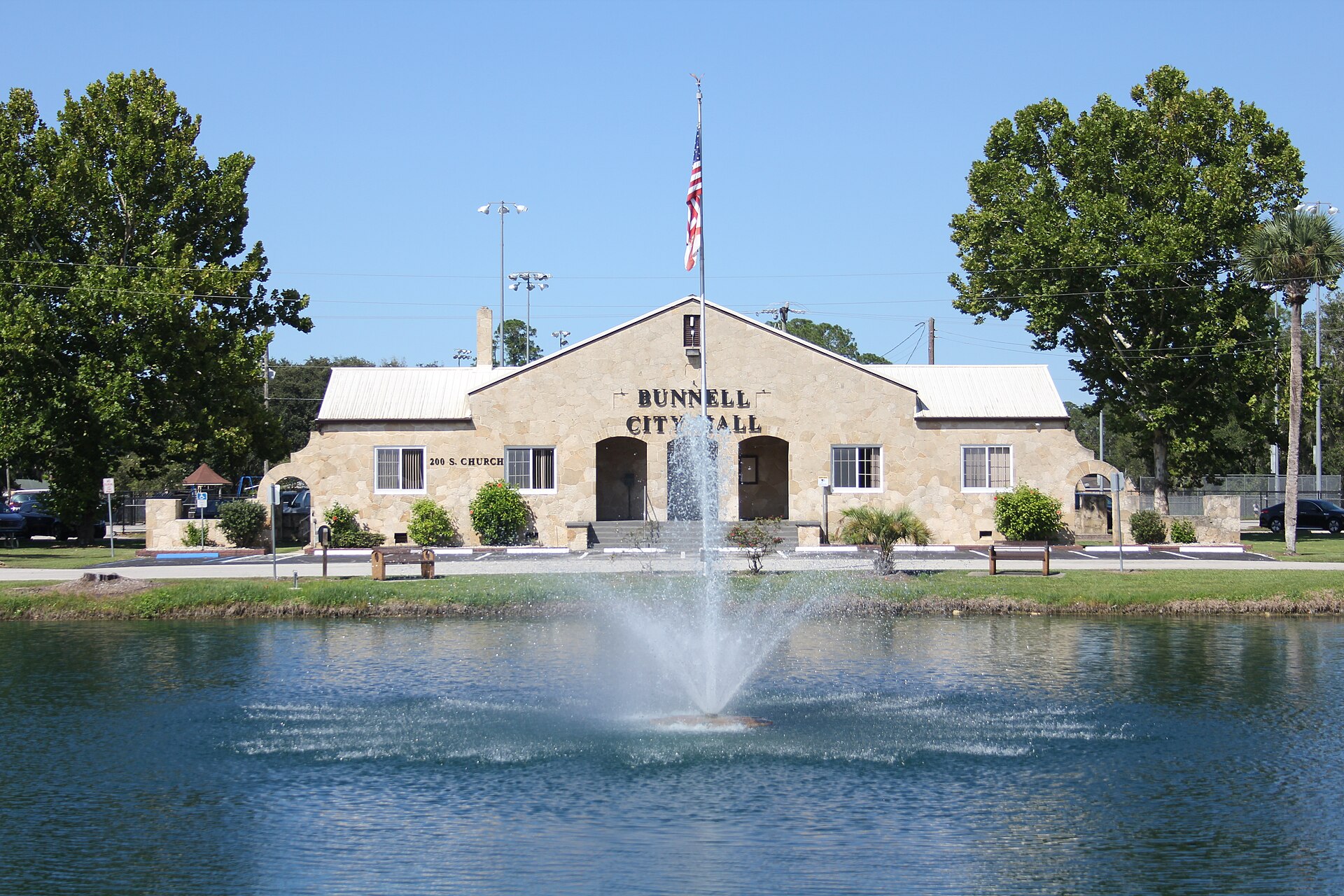 Photograph of the Bunnell Coquina City Hall - Full Front View with Lake Lucille & Fountain — Florida