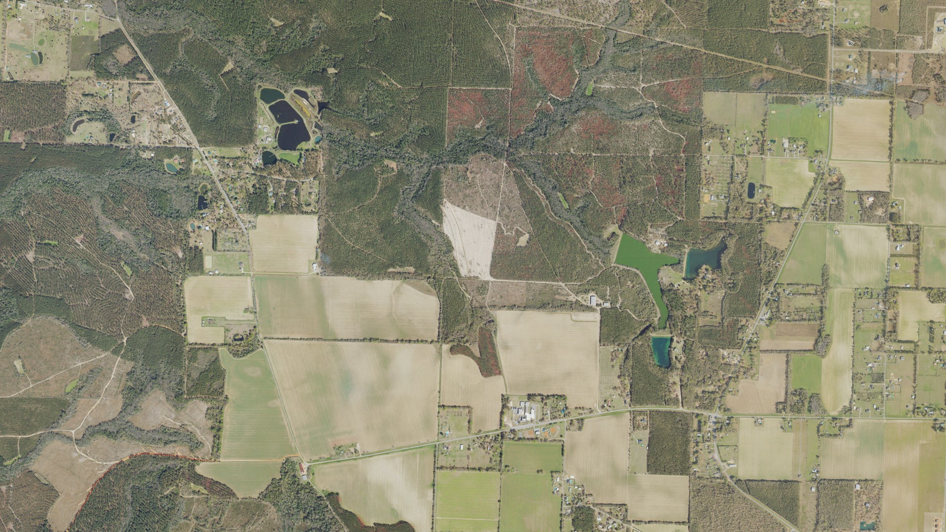 Natural-color aerial photograph of land around Chumuckla, Florida