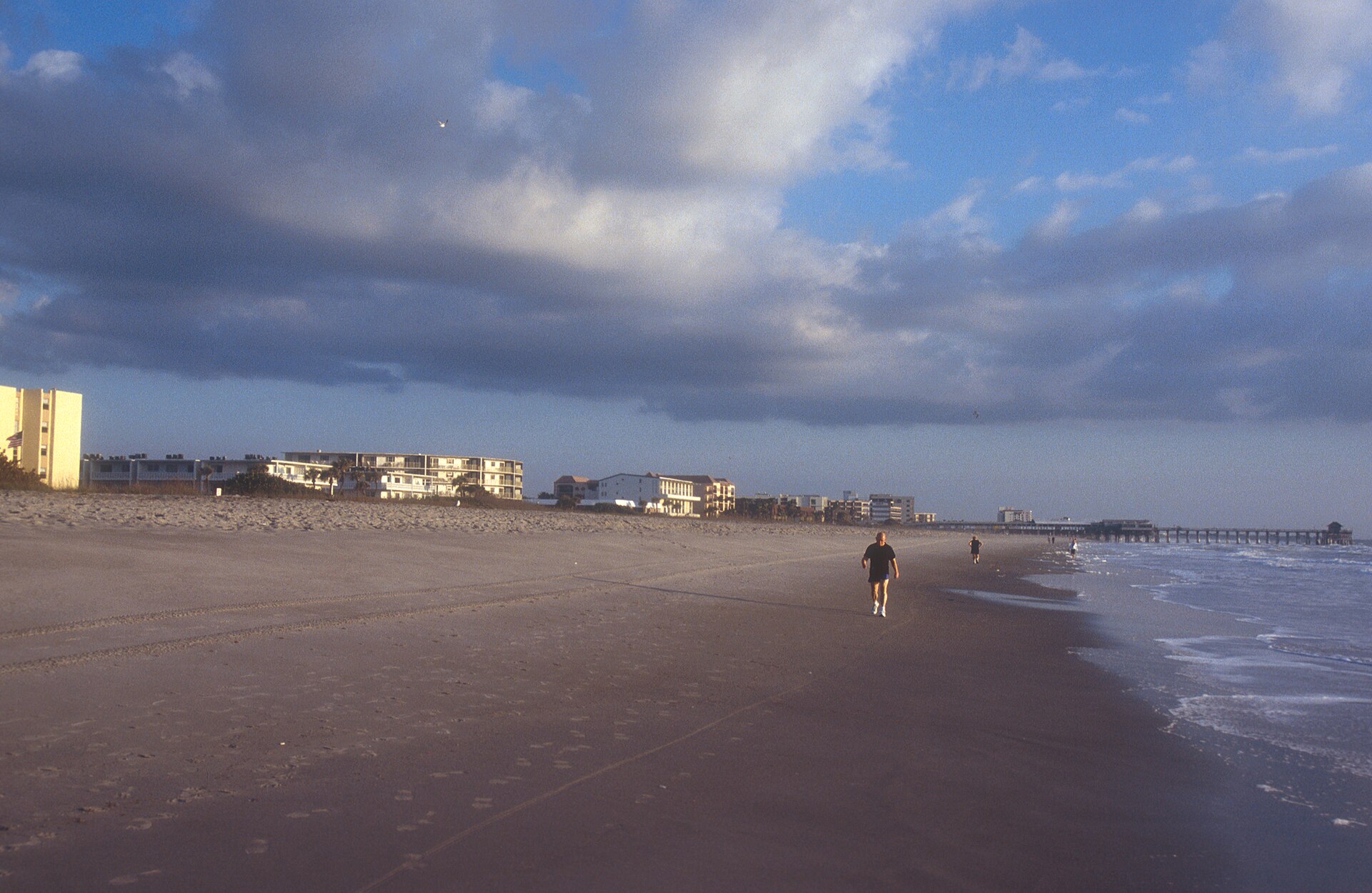 Scope and content: The original finding aid described this photograph as: Original Caption: Clouds may keep some visitors away, but others enjoy the solitude of having the beach all to themselves. — Cocoa Beach, Florida