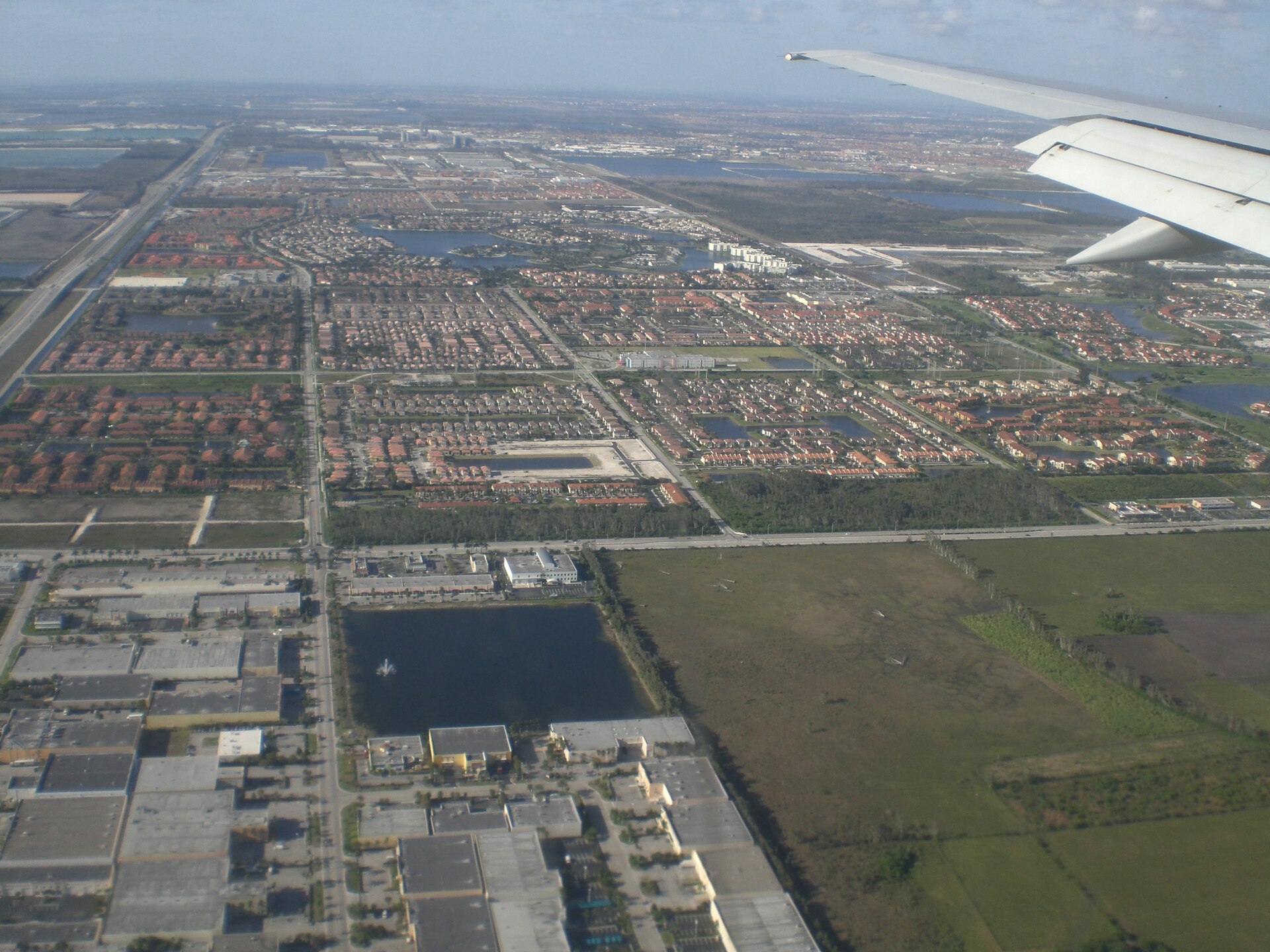 Aerial view of western Doral. Florida's Turnpike is visible in the upper left and one of the few remaining cow pastures in the Miami area is in the lower right. Western Doral from jet window. 4/1/2007.