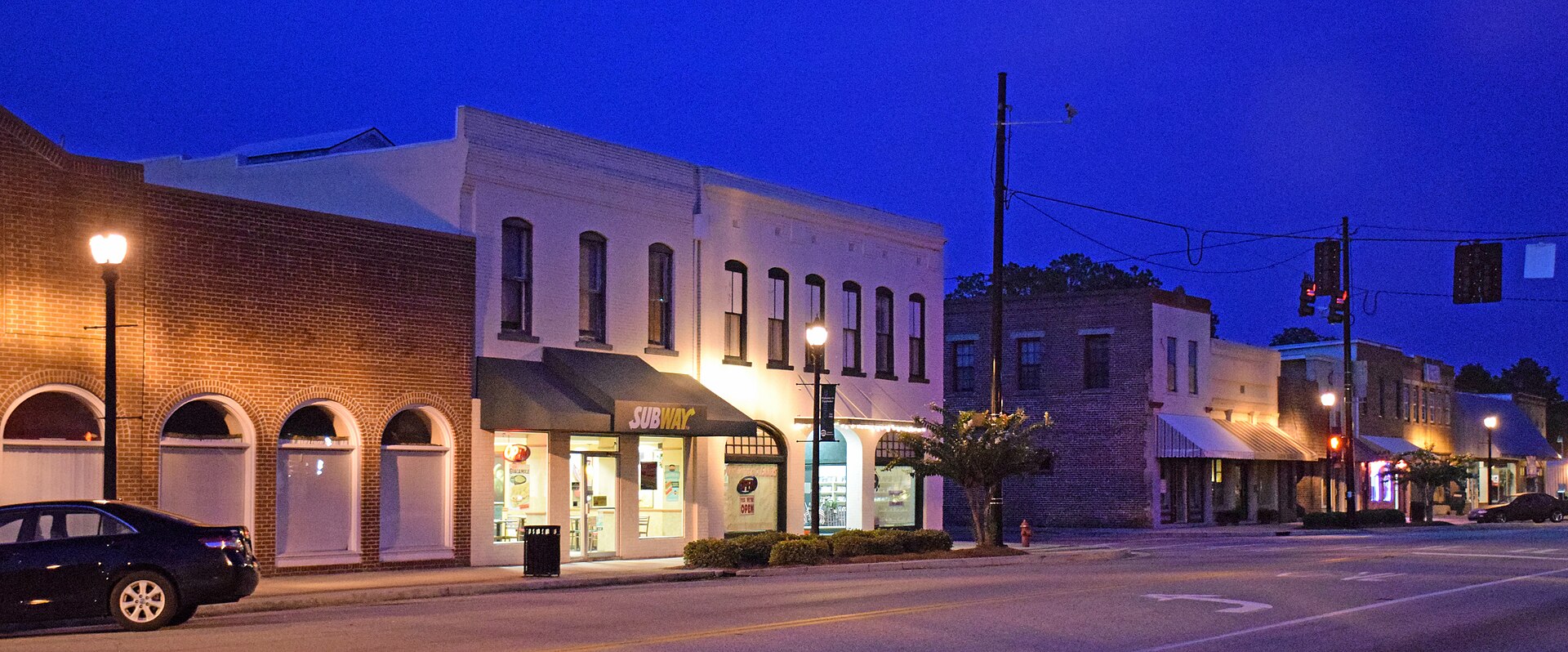Pembroke Historic District. The road pictured is US 280 and the buildings near the center are separated by Main Street. — Georgia