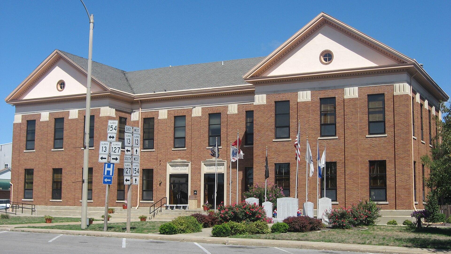 Front and eastern side of the Perry County Courthouse, located along Illinois Routes 13, 127, and 154 on Courthouse Square in Pinckneyville, Illinois, United States.
