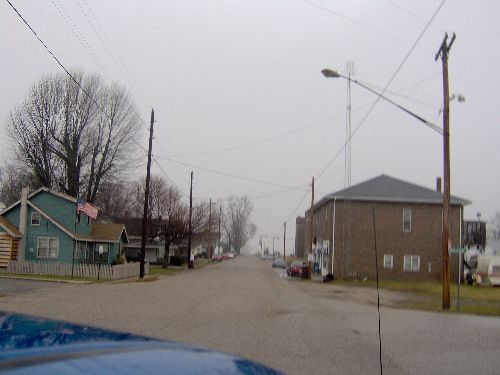 View of the main street of Onward, Indiana, taken out of the window of the car visible in the bottom left corner. Picture taken by Nyttend on 15 January 2007.