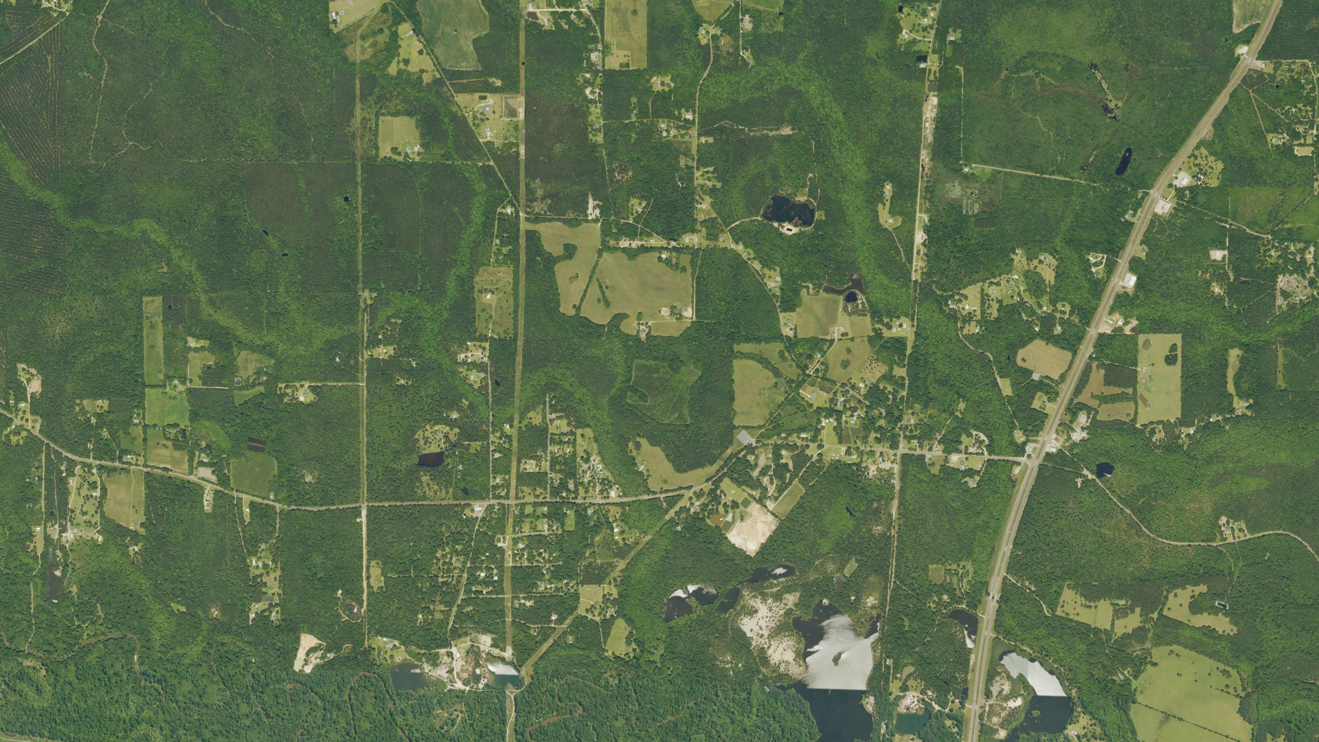 Natural-color aerial photograph of land around Sun, Louisiana