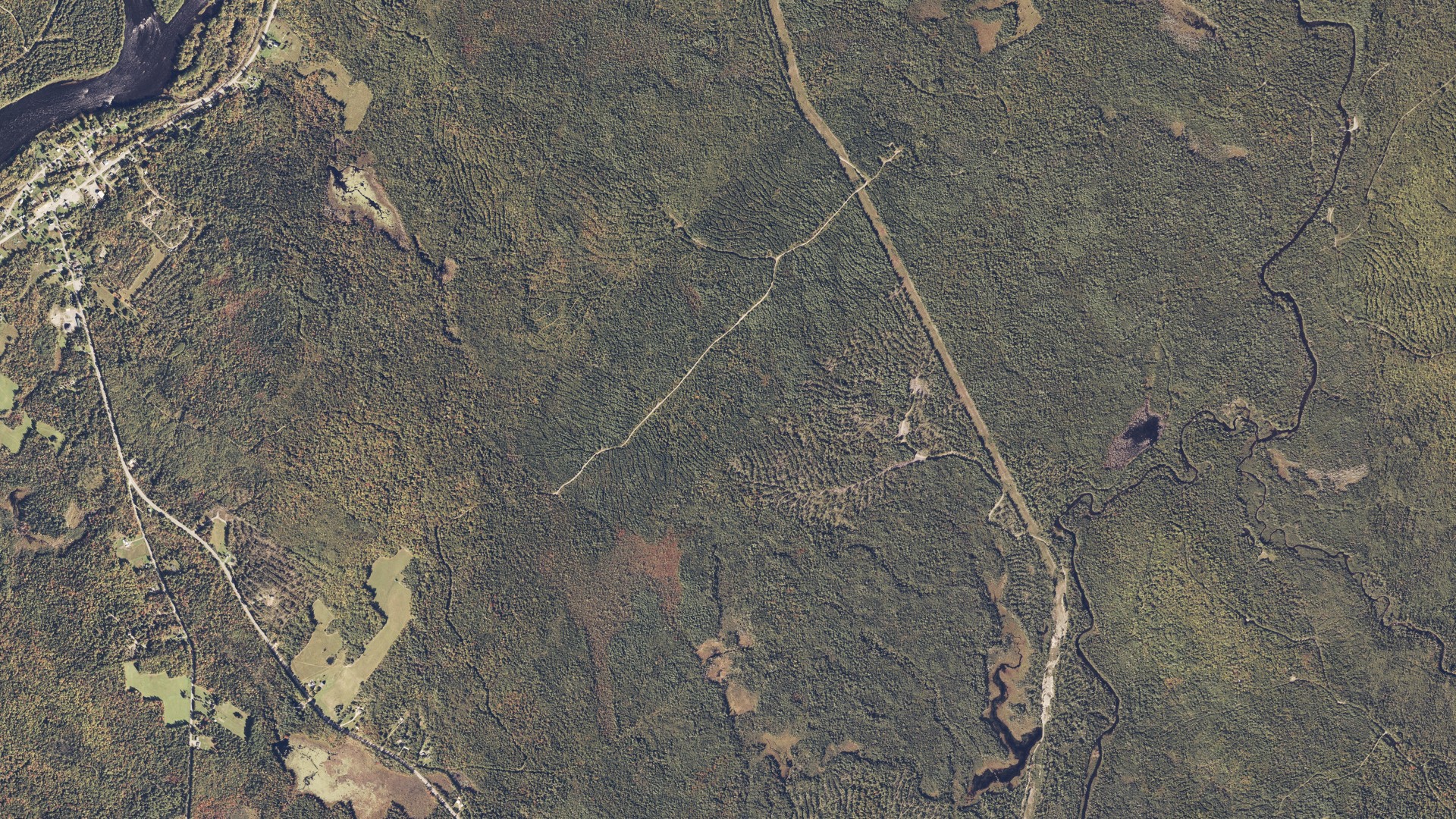 Natural-color aerial photograph of land around Winn, Maine