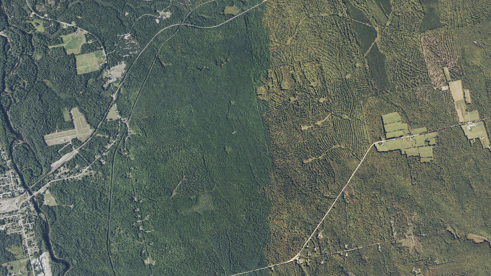Natural-color aerial photograph of land around Brownville, Maine