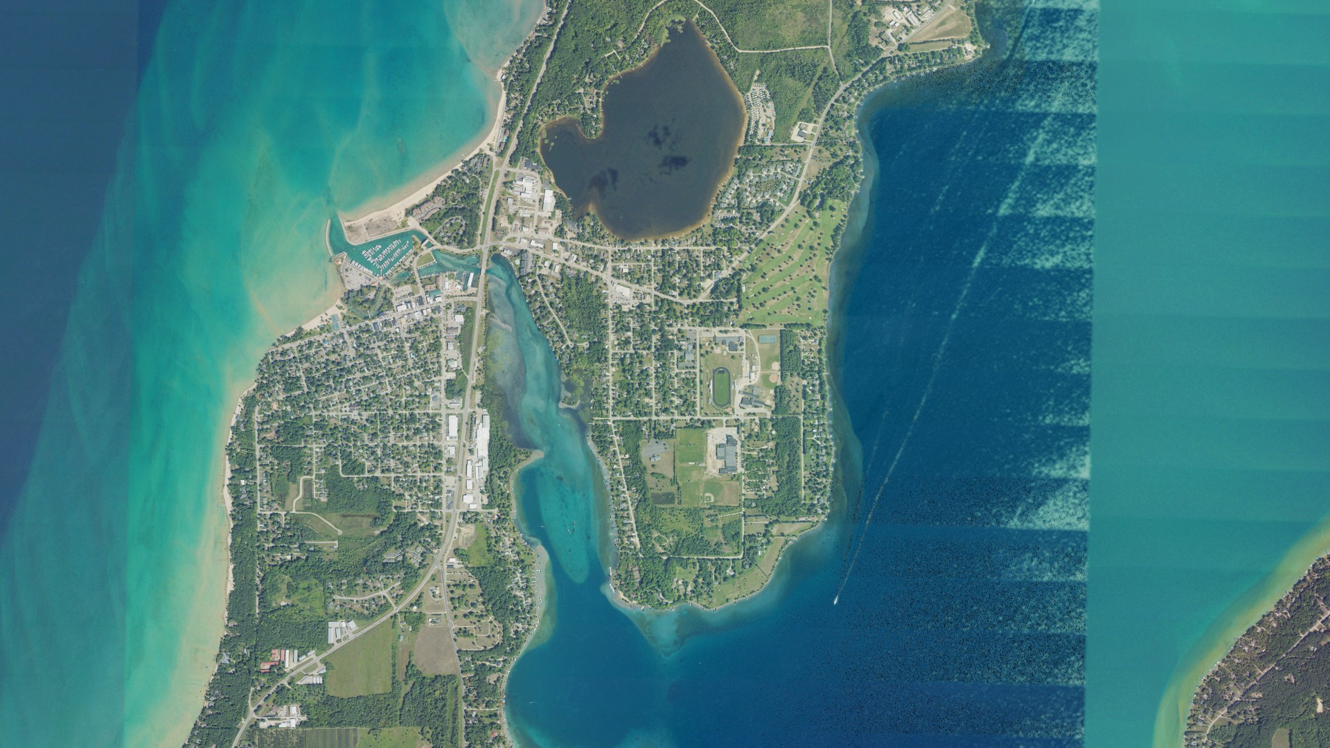 Natural-color aerial photograph of land around Elk Rapids, Michigan