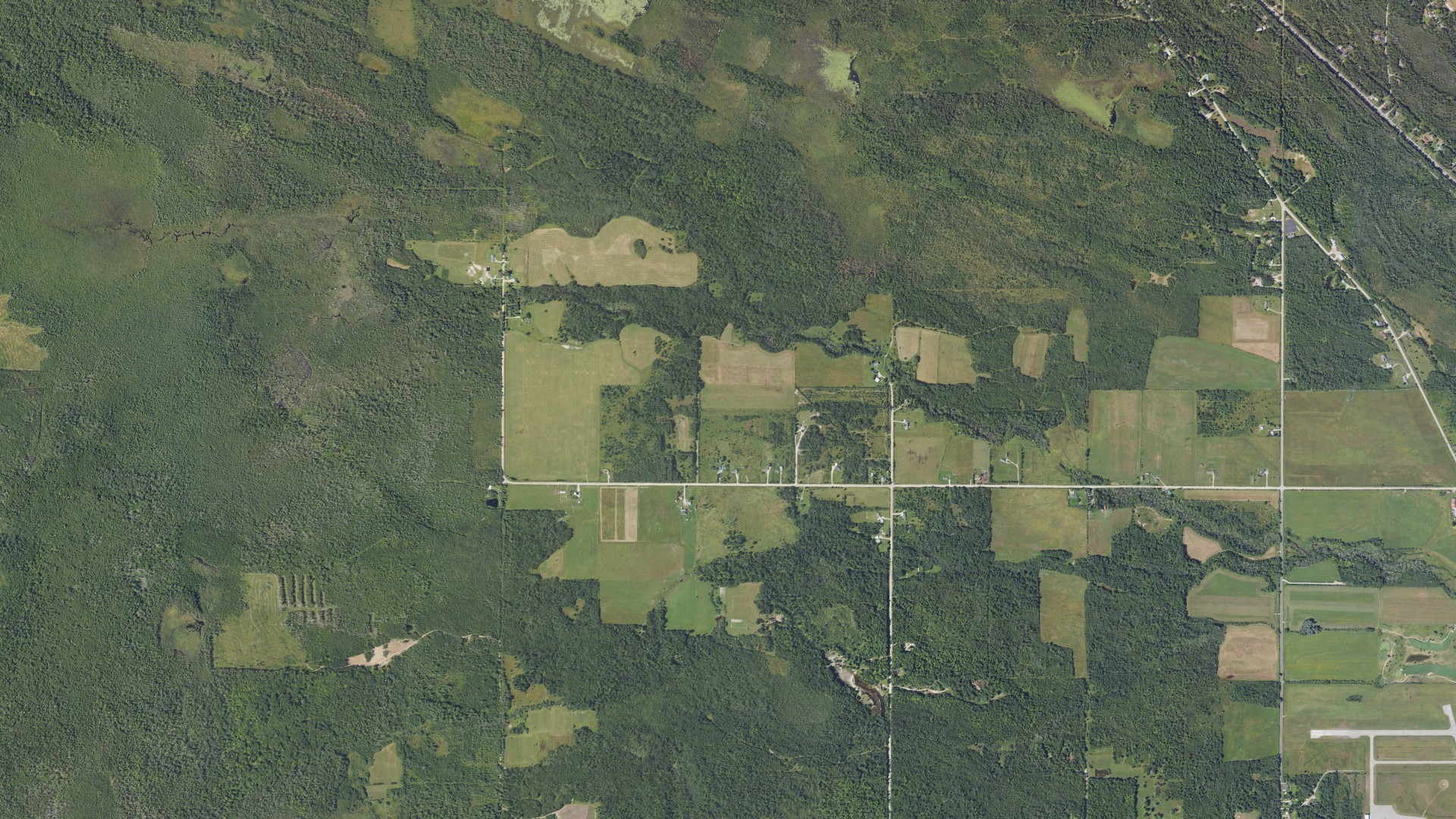 Natural-color aerial photograph of land around Beaugrand, Michigan