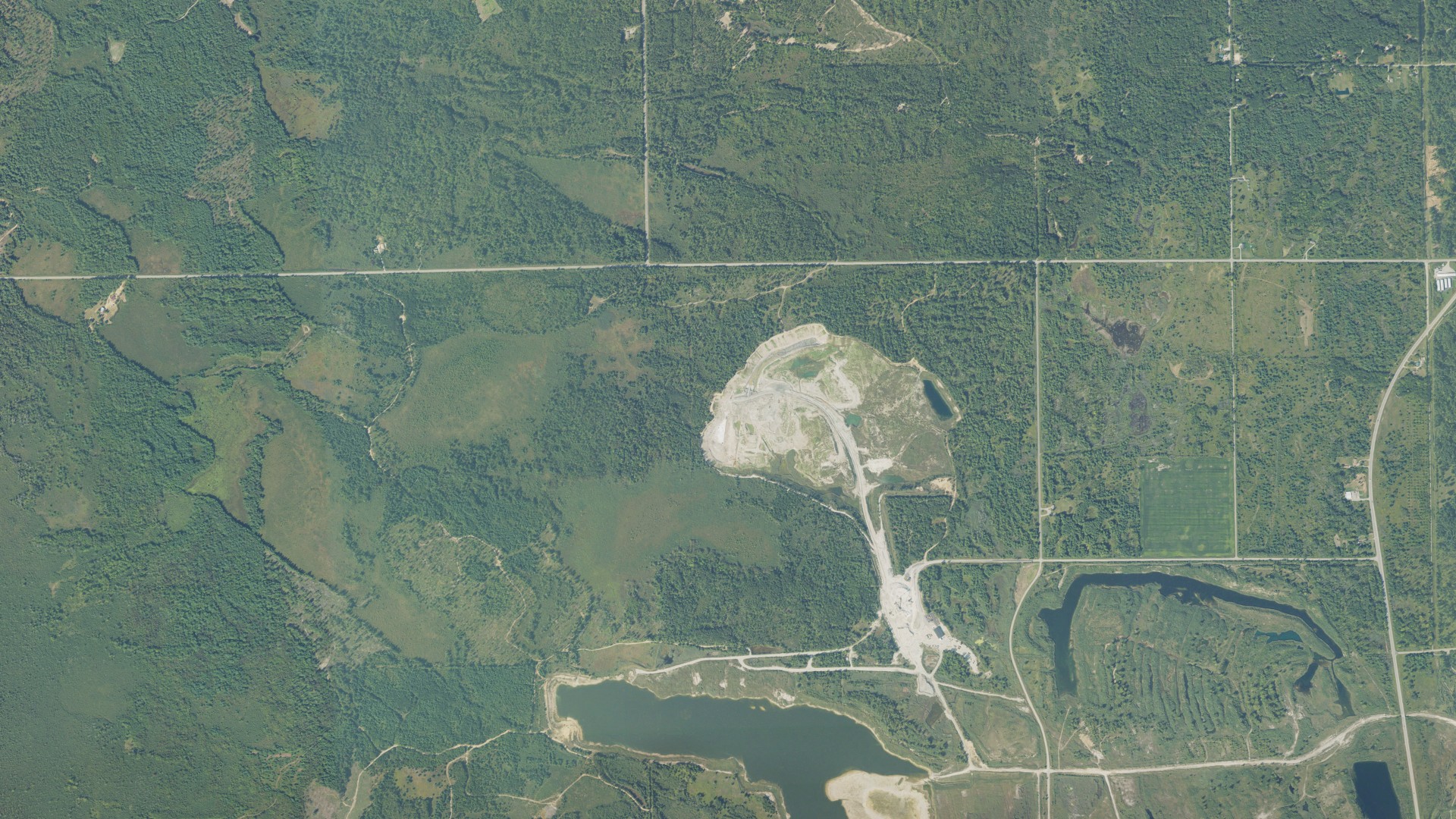 Natural-color aerial photograph of land around Alabaster, Michigan