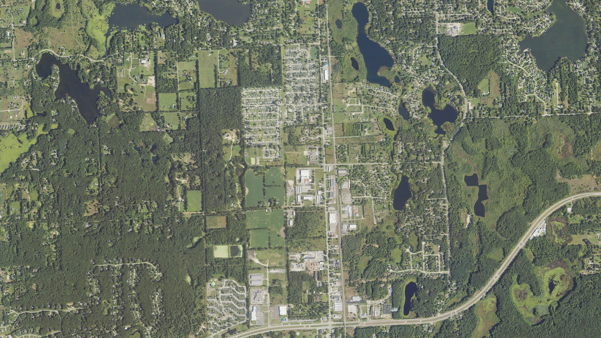 Natural-color aerial photograph of land around Highland charter, Michigan