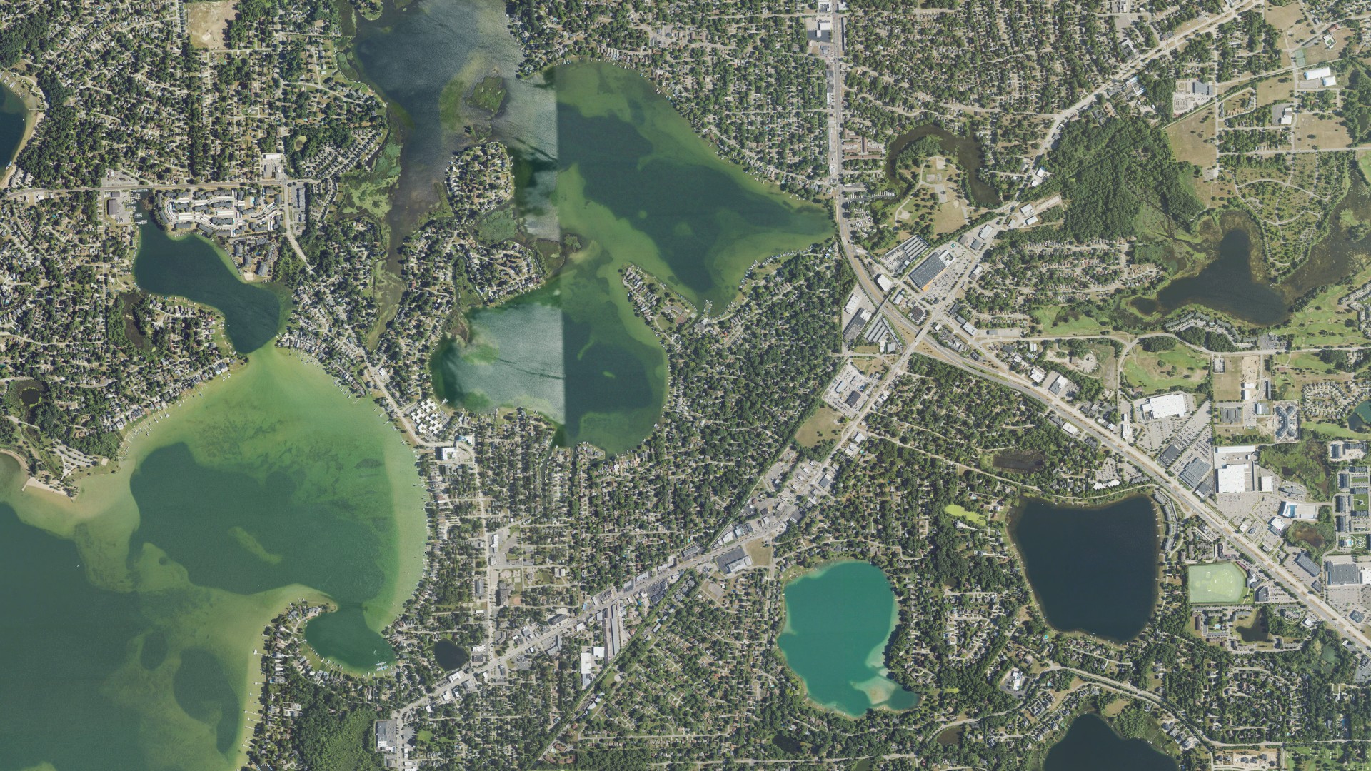 Natural-color aerial photograph of land around Sylvan Lake, Michigan