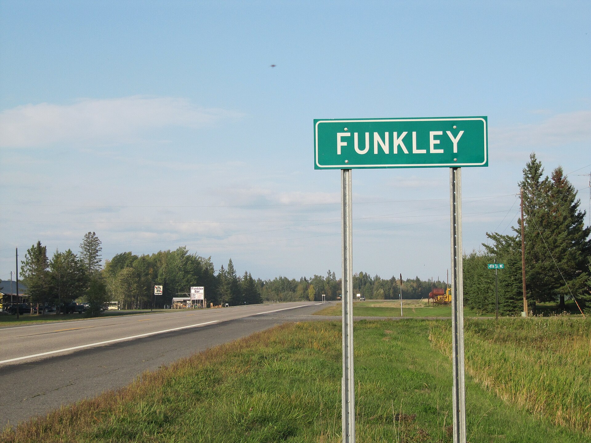 Funkley, MN road sign with Funkley Bar in the background. County Road 71. — Minnesota