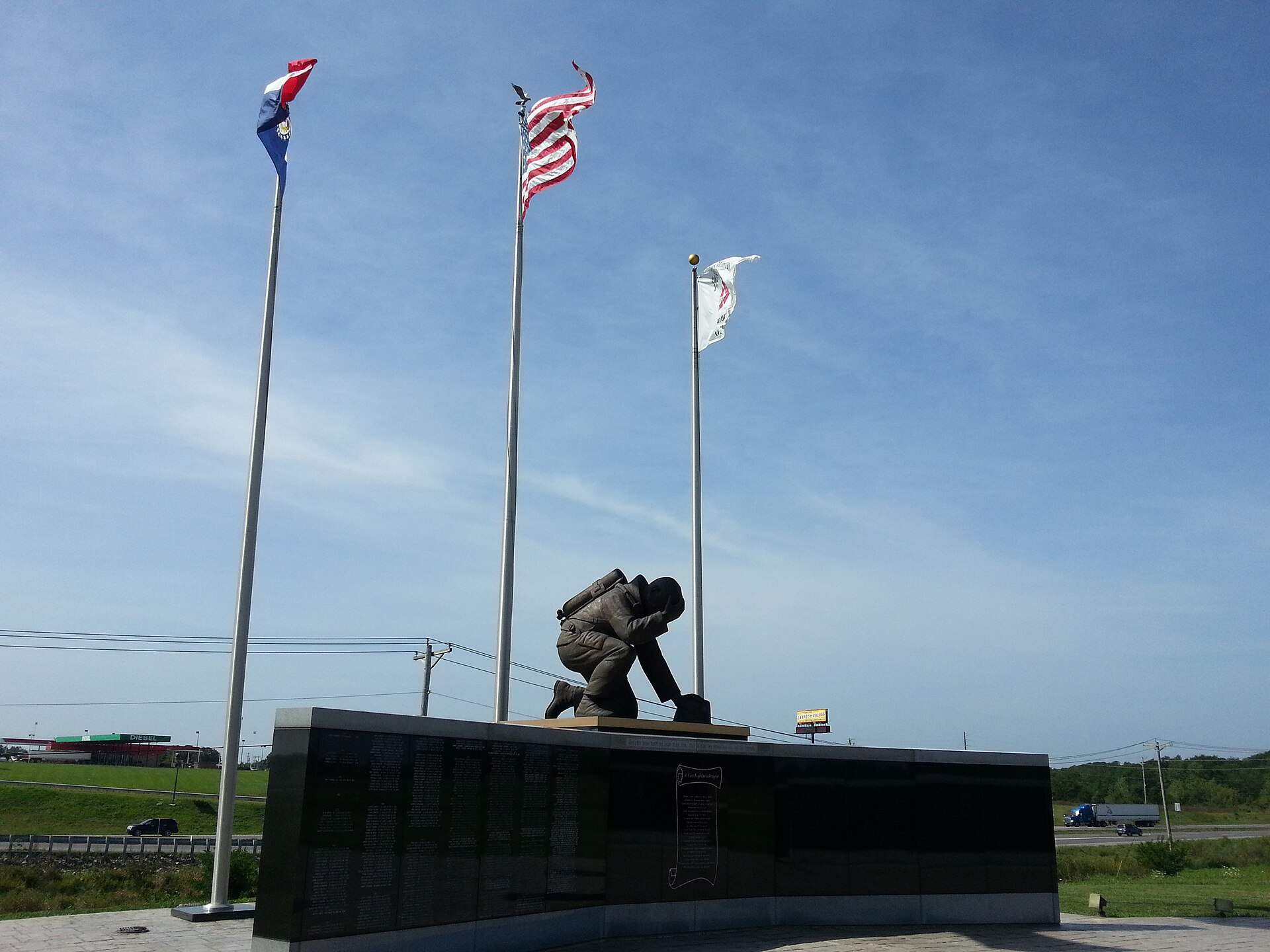 "Fire Fighter in Prayer" atop memorial wall, Kingdom City, Missouri