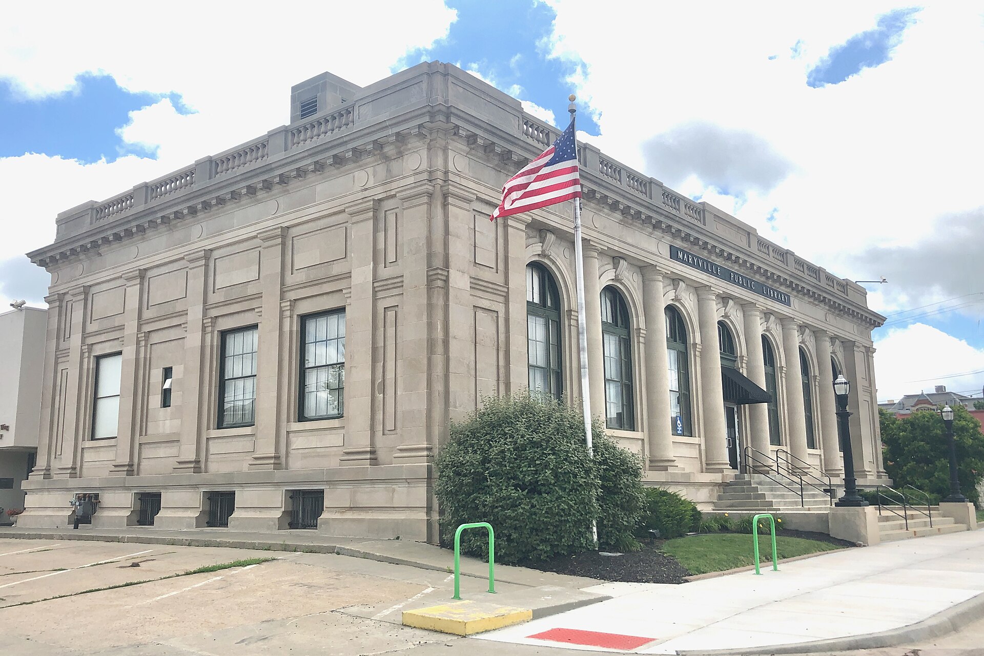 Maryville Post Office The building is covered by a low-profile hipped roof with a flat top, and rimmed at the edge with an original limestone balustrade on the west, north and south. — Missouri