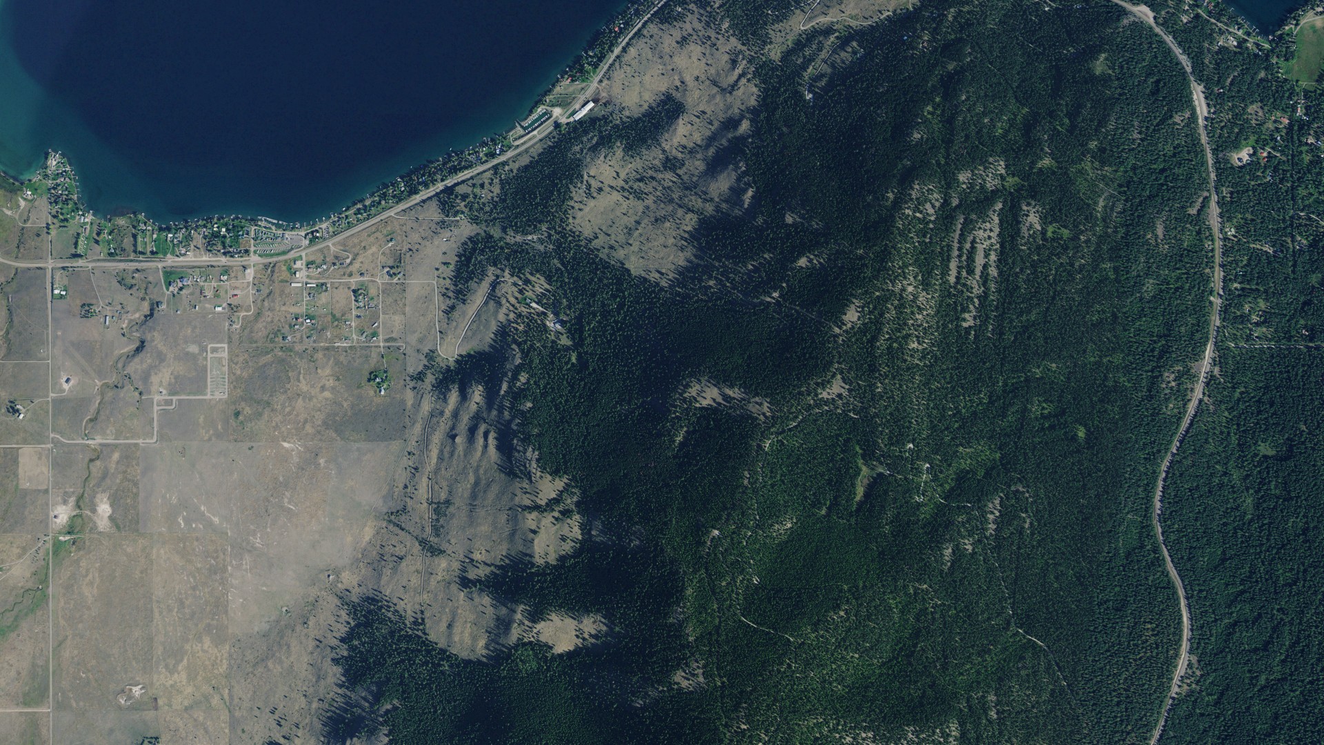 Natural-color aerial photograph of land around Big Arm, Montana