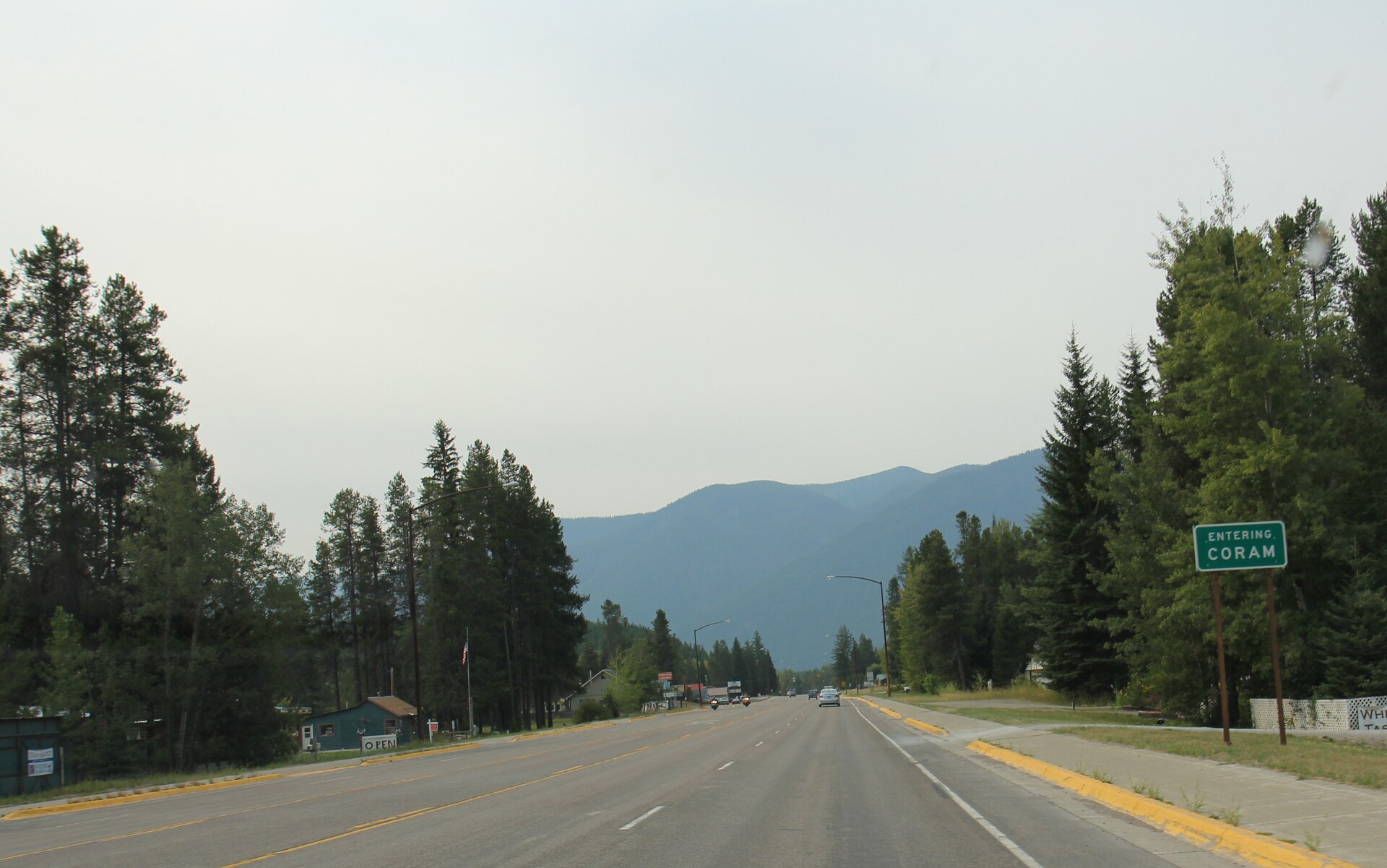 Looking westerly at the sign for Coram, Montana on U.S. Route 2.