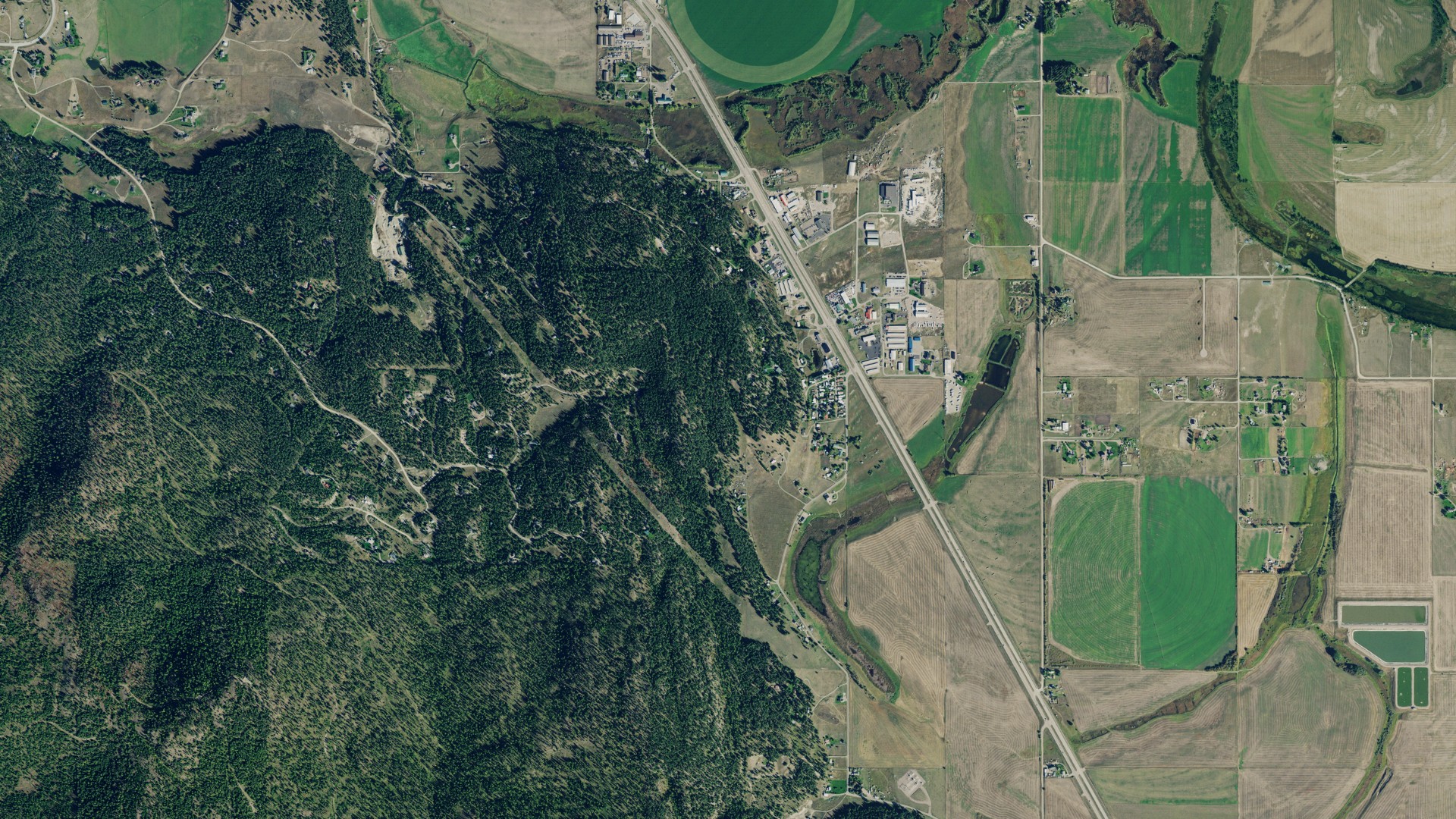 Natural-color aerial photograph of land around Forest Hill Village, Montana
