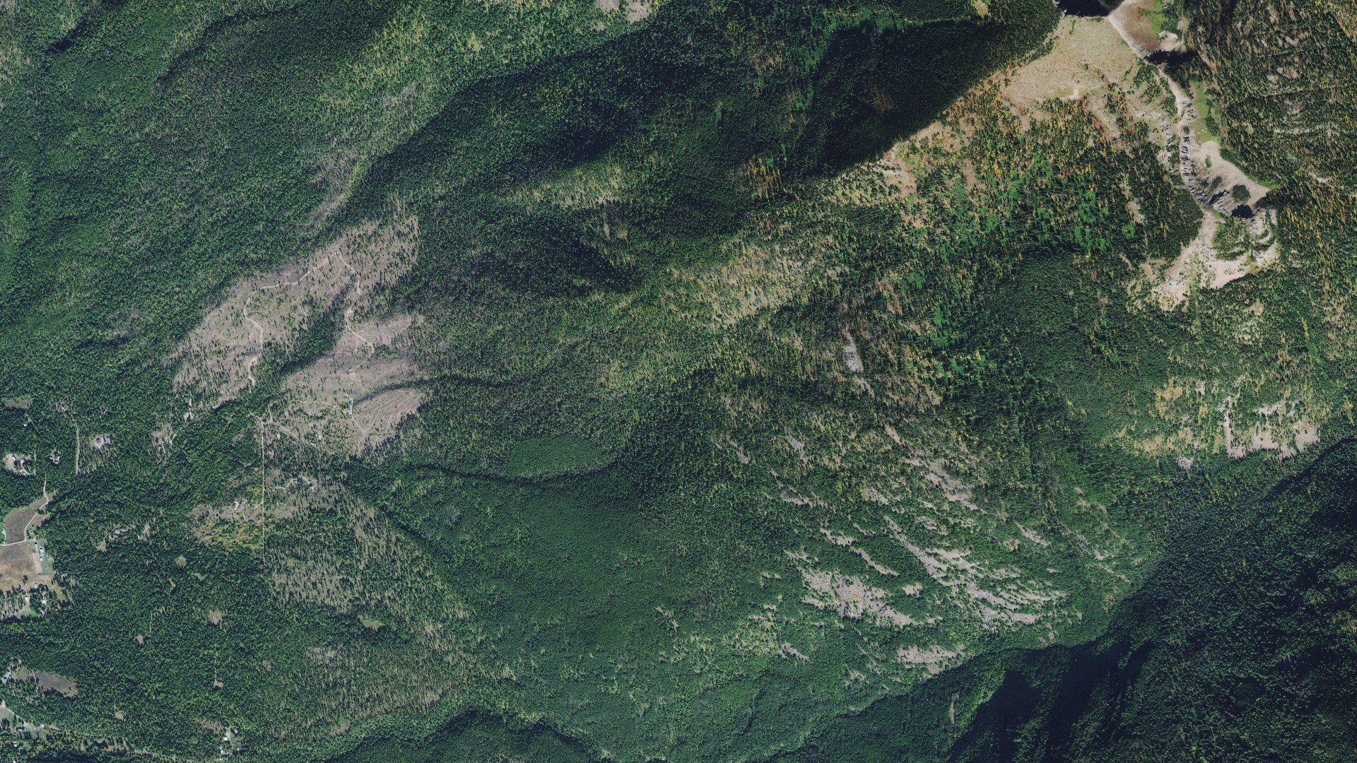 Natural-color aerial photograph of land around Swan Lake, Montana
