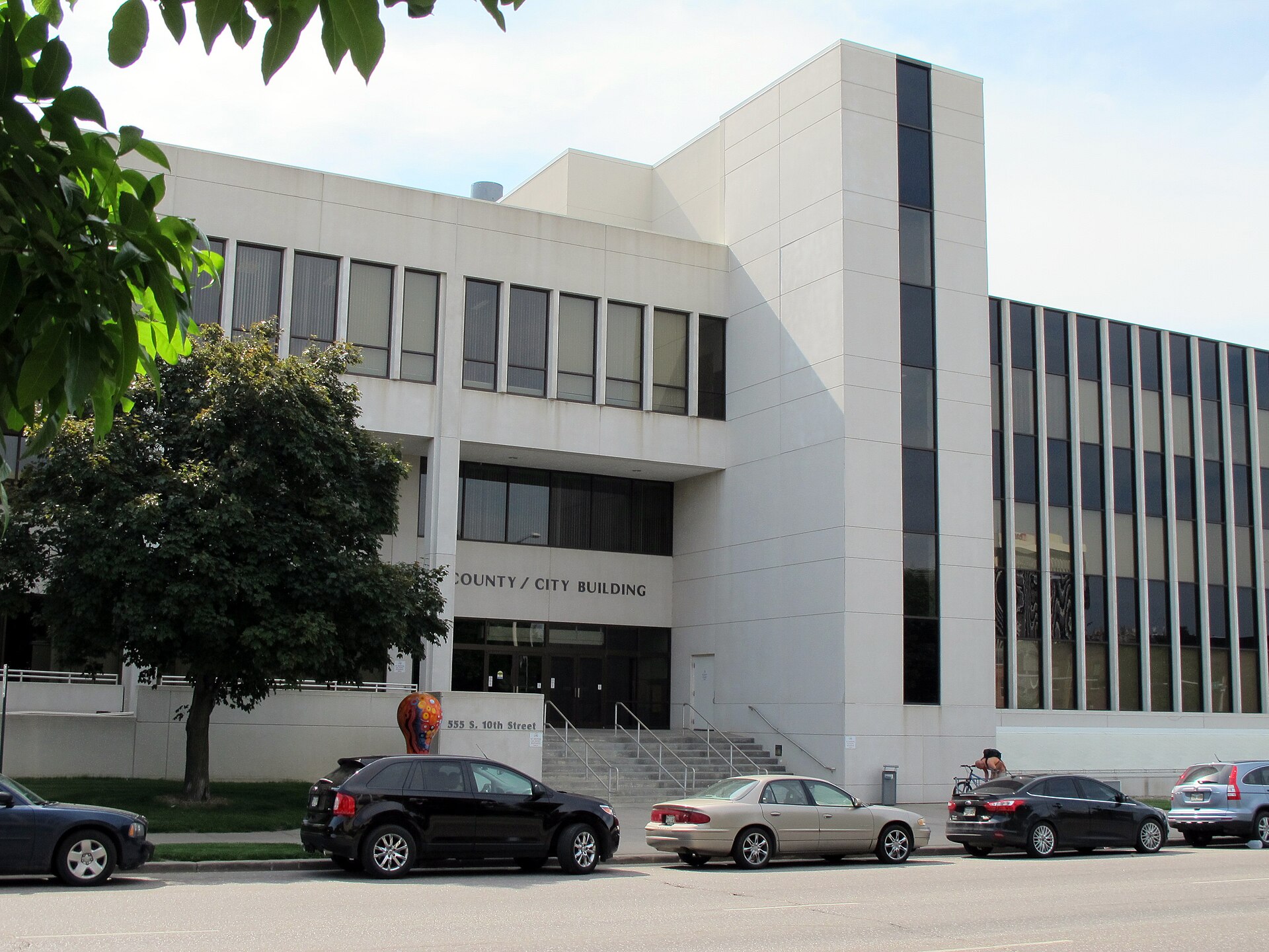Photo of the (new) County-City Building, 555 S.10th Street in Lincoln, Nebraska. Photo is taken from the east side of S. 10th Street, looking west-northwest at the main entrance (east side) of the building. — Lancaster County, Nebraska