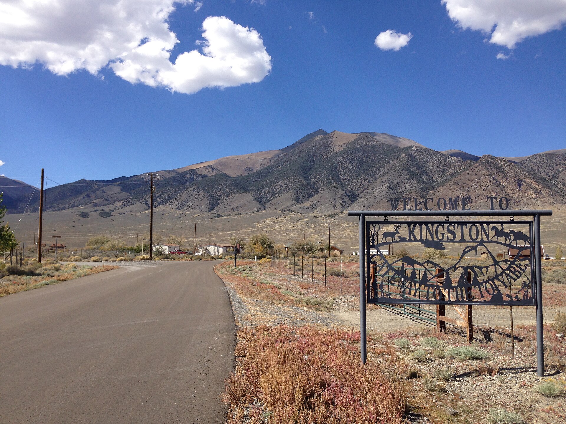 Sign along Tahoe Road at the entrance to Kingston, Nevada, with Bunker Hill visible in the background