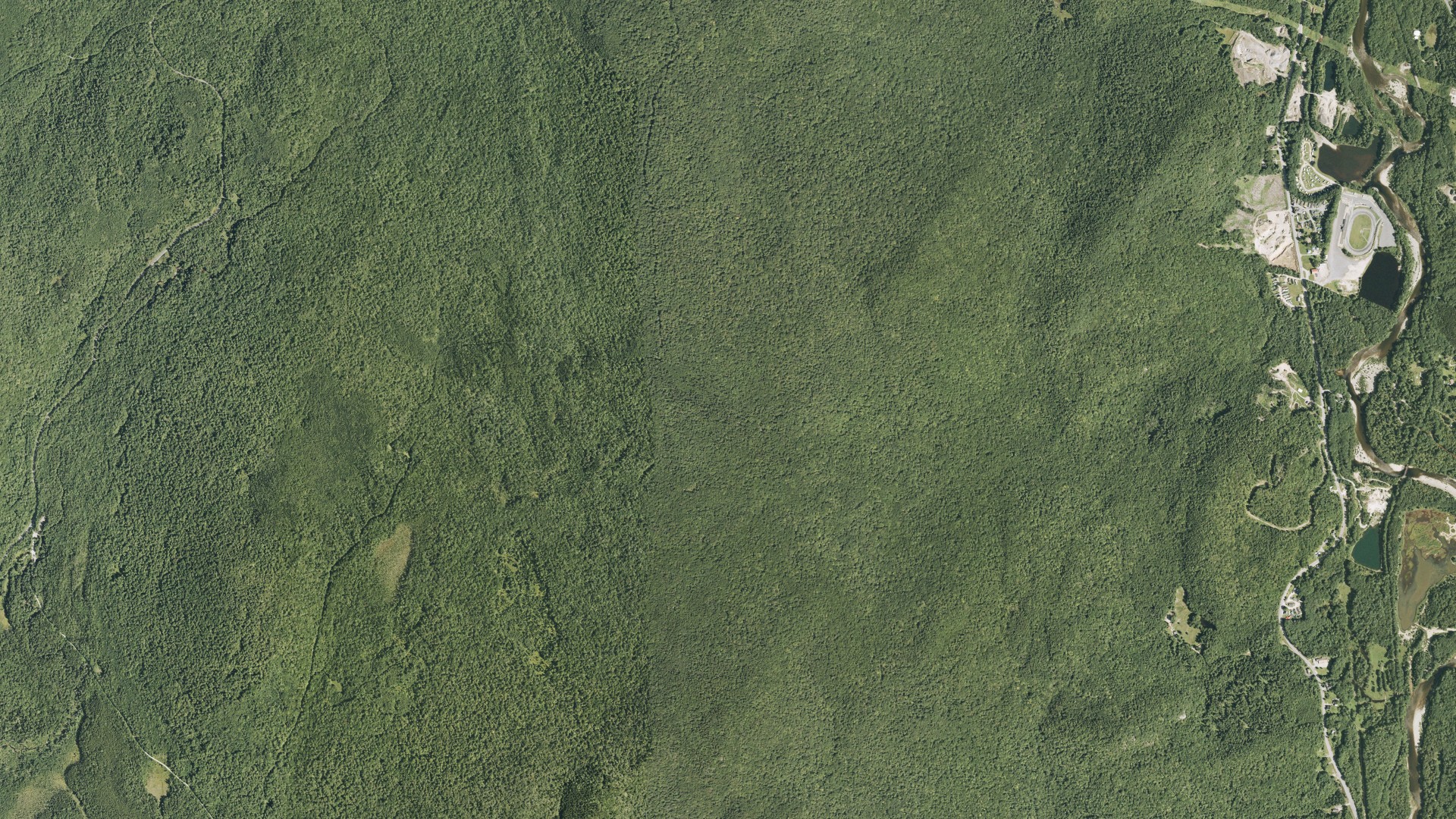 Natural-color aerial photograph of land around Woodstock, New Hampshire