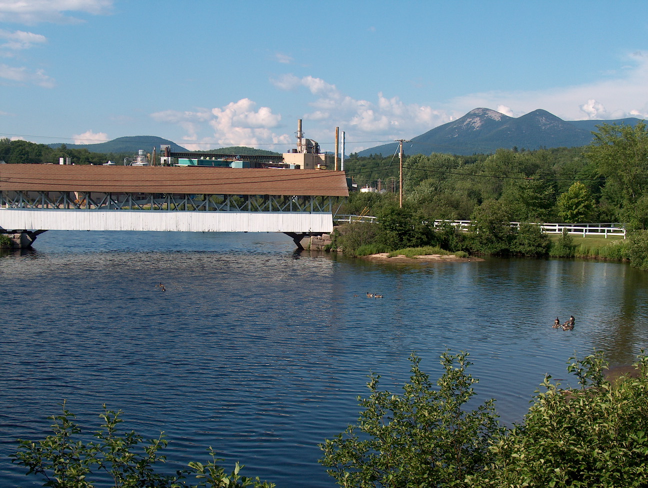 View of village of Groveton, along the Upper Ammonoosuc River. Percy Peaks in the background. Photo by Ken Gallager. — New Hampshire