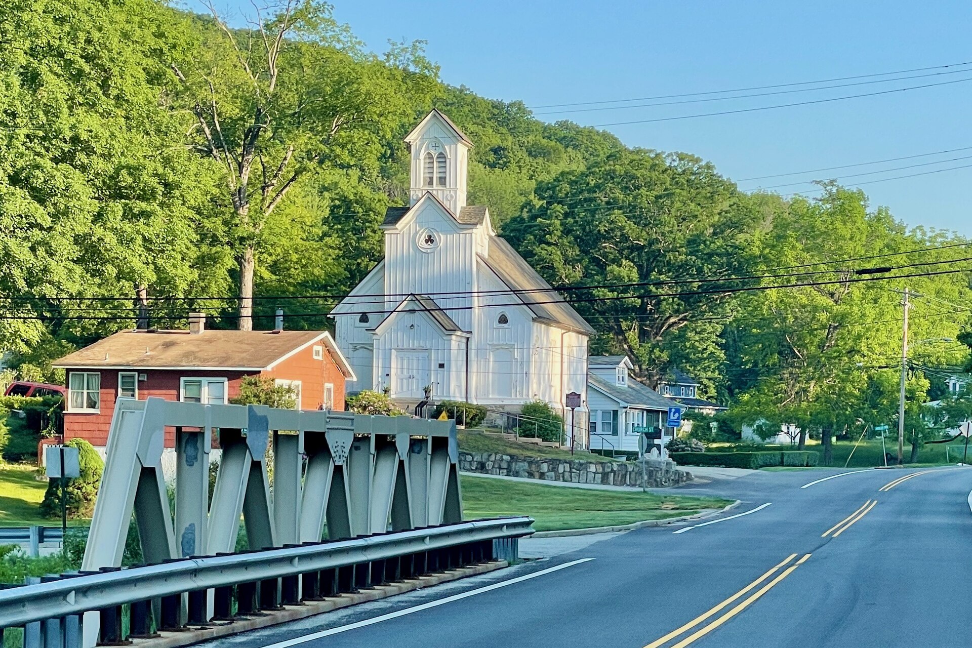 Area view of Hibernia, New Jersey along County Route 513 (Green Pond Road). Features the former Methodist Episcopal Church, now a public library. Road bridge crossing Hibernia Brook is in the foreground.