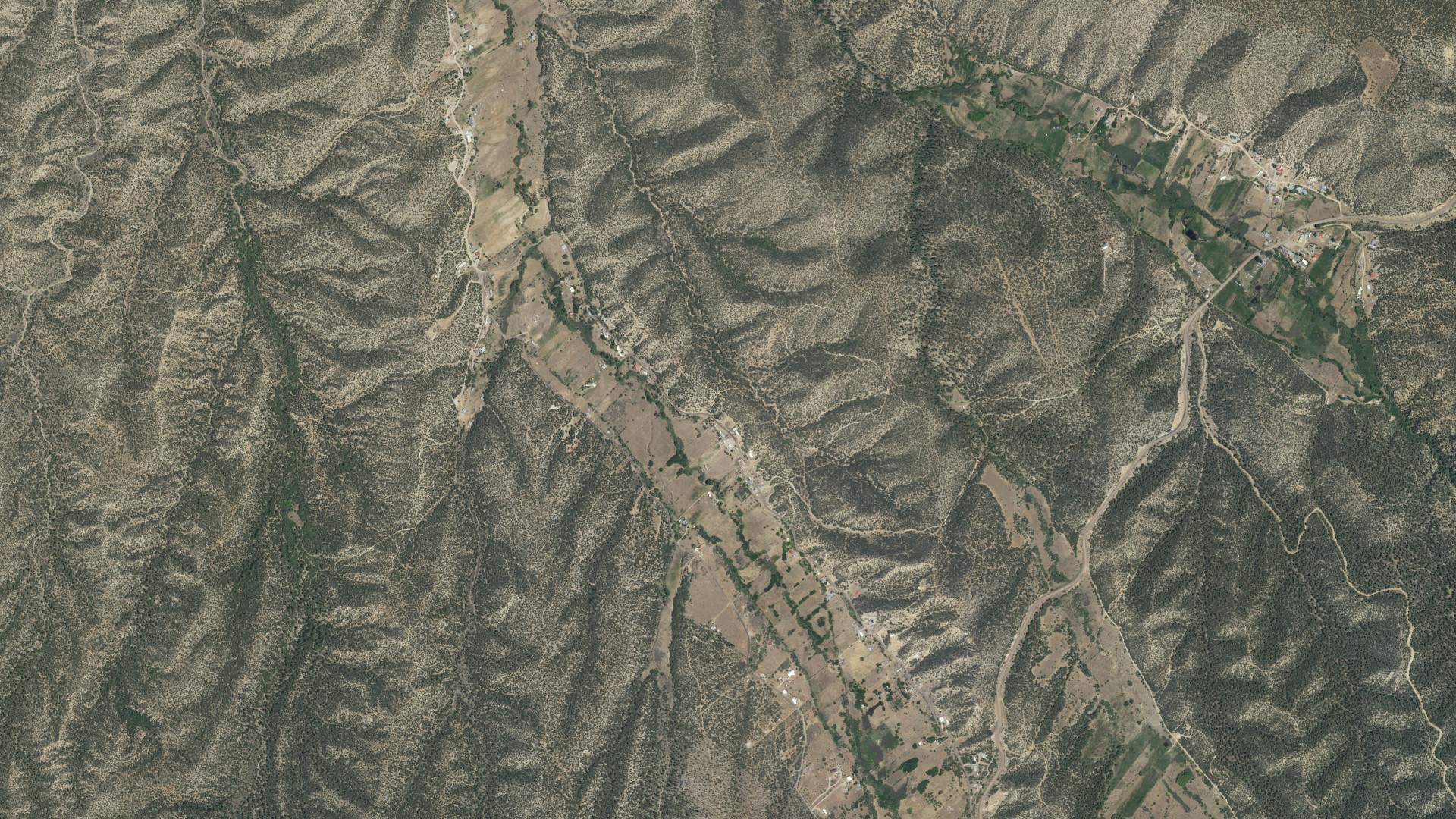 Natural-color aerial photograph of land around Ojo Sarco, New Mexico
