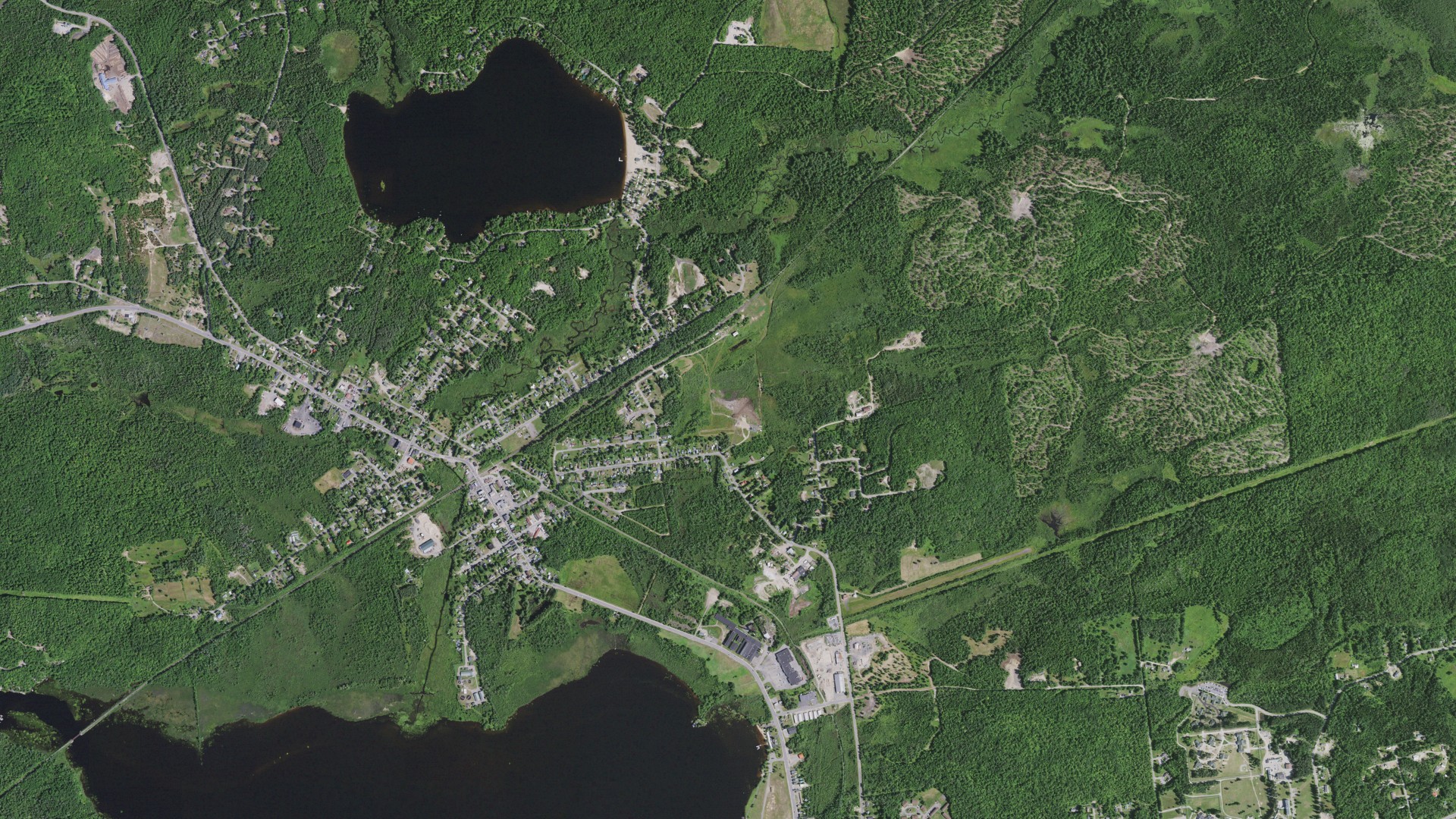 Natural-color aerial photograph of land around Tupper Lake, New York