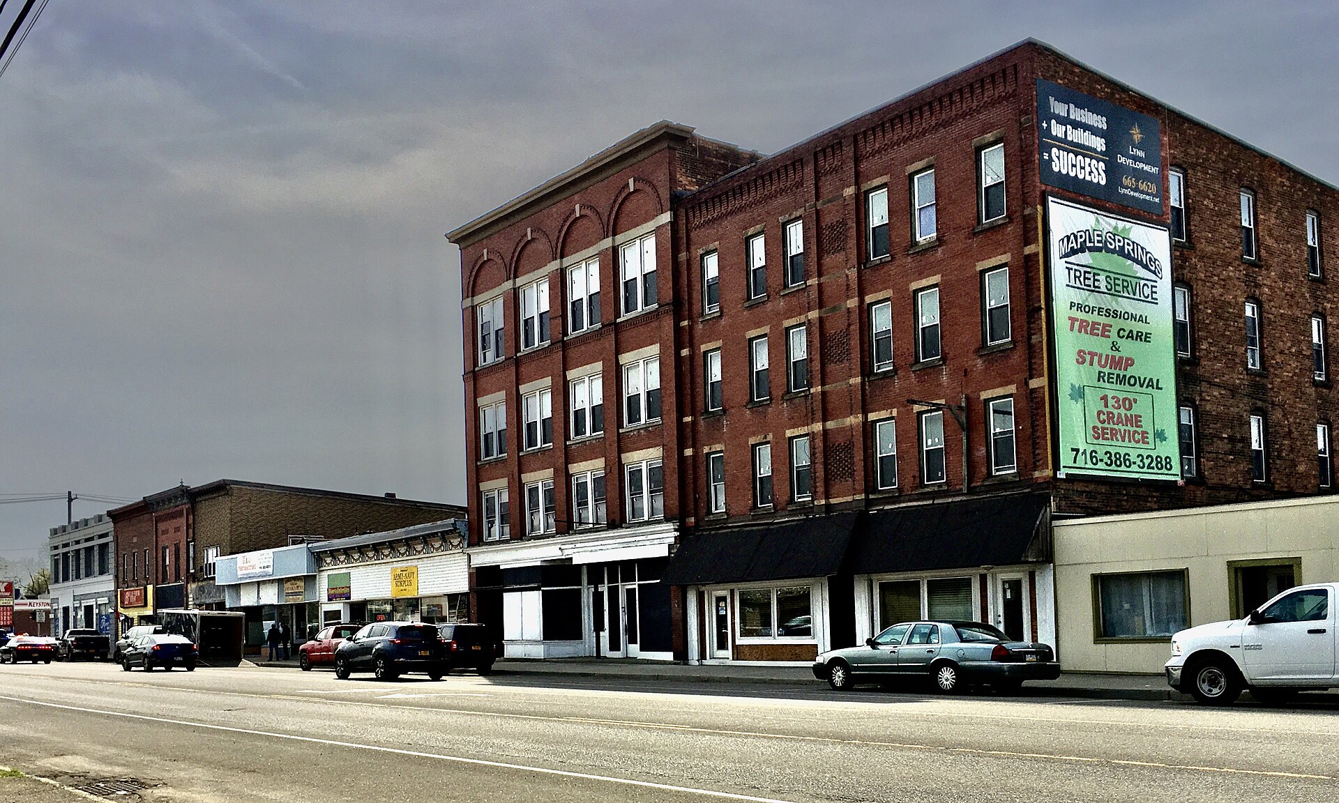 A view of East Main Street in downtown Falconer, New York - specifically the north side thereof, just east of Work Street - in April 2021.
