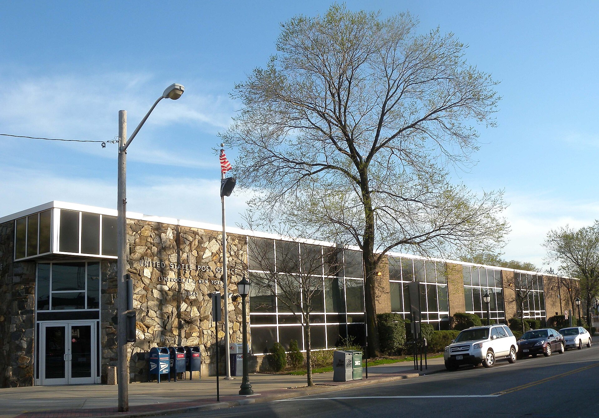 Looking south across Broadway and Eldert at post office of Lynbrook, New York late on a sunny afternoon.