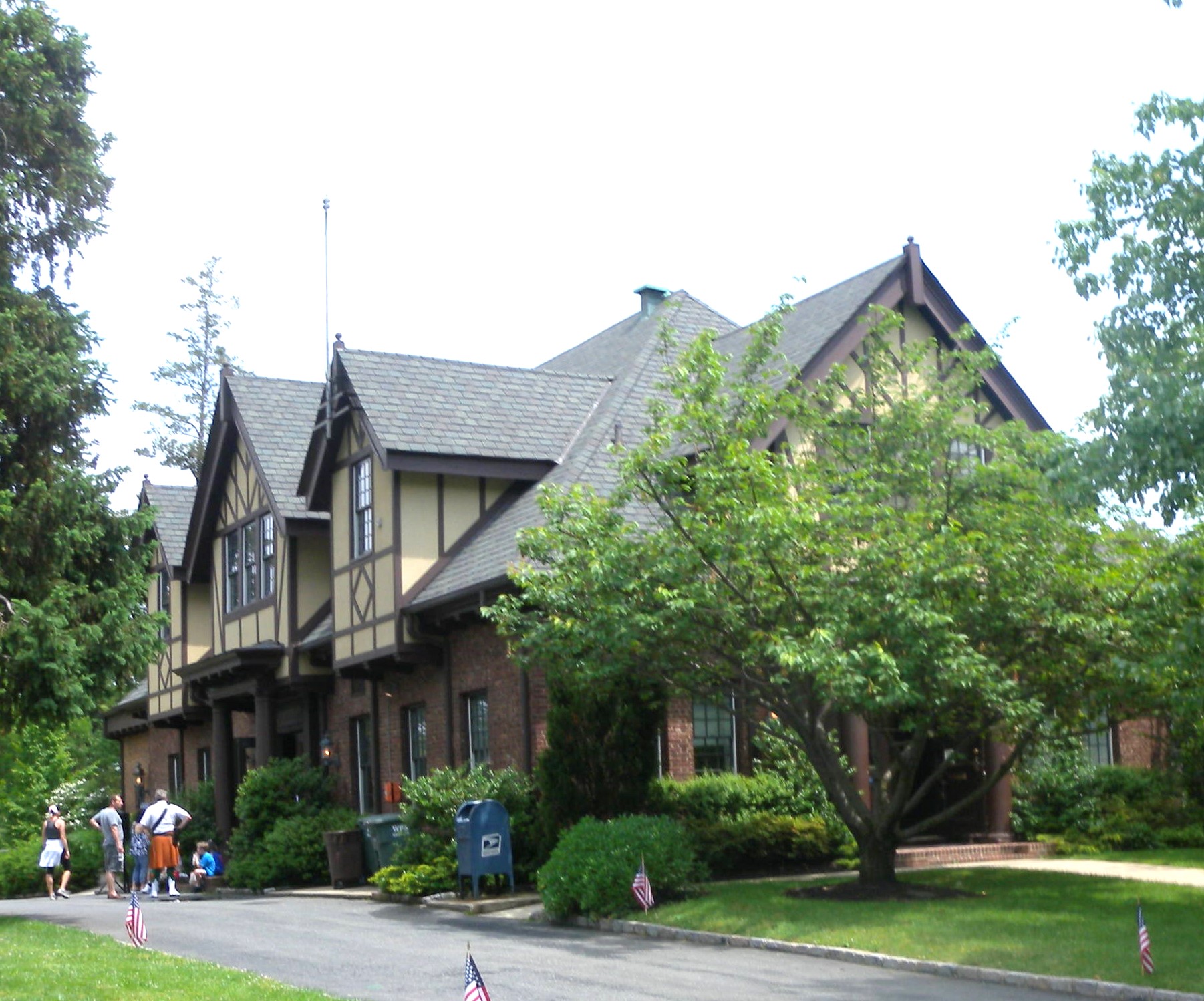 Looking north at Plandome Village Hall on a partly sunny midday. — New York