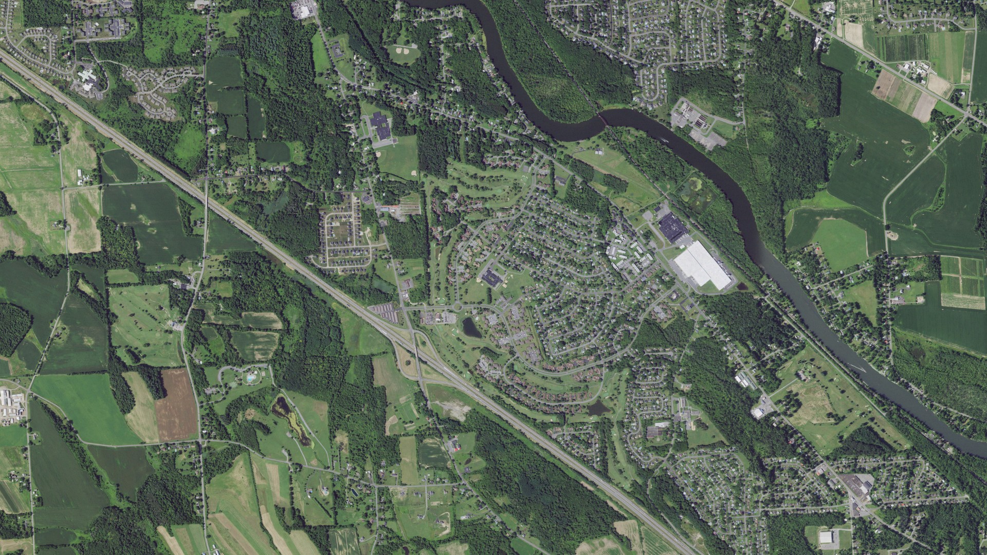 Natural-color aerial photograph of land around Village Green, New York