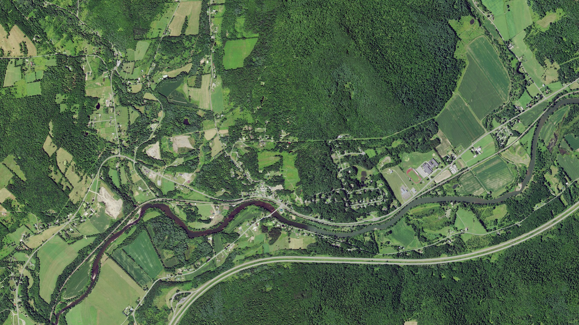 Natural-color aerial photograph of land around Wells Bridge, New York